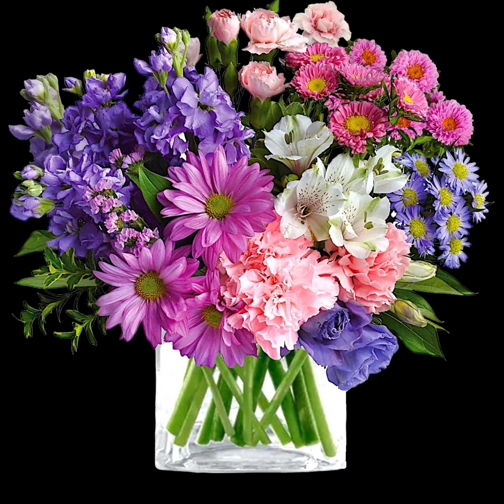 Mixed bouquet of pink, purple, white, and blue flowers in a clear glass vase