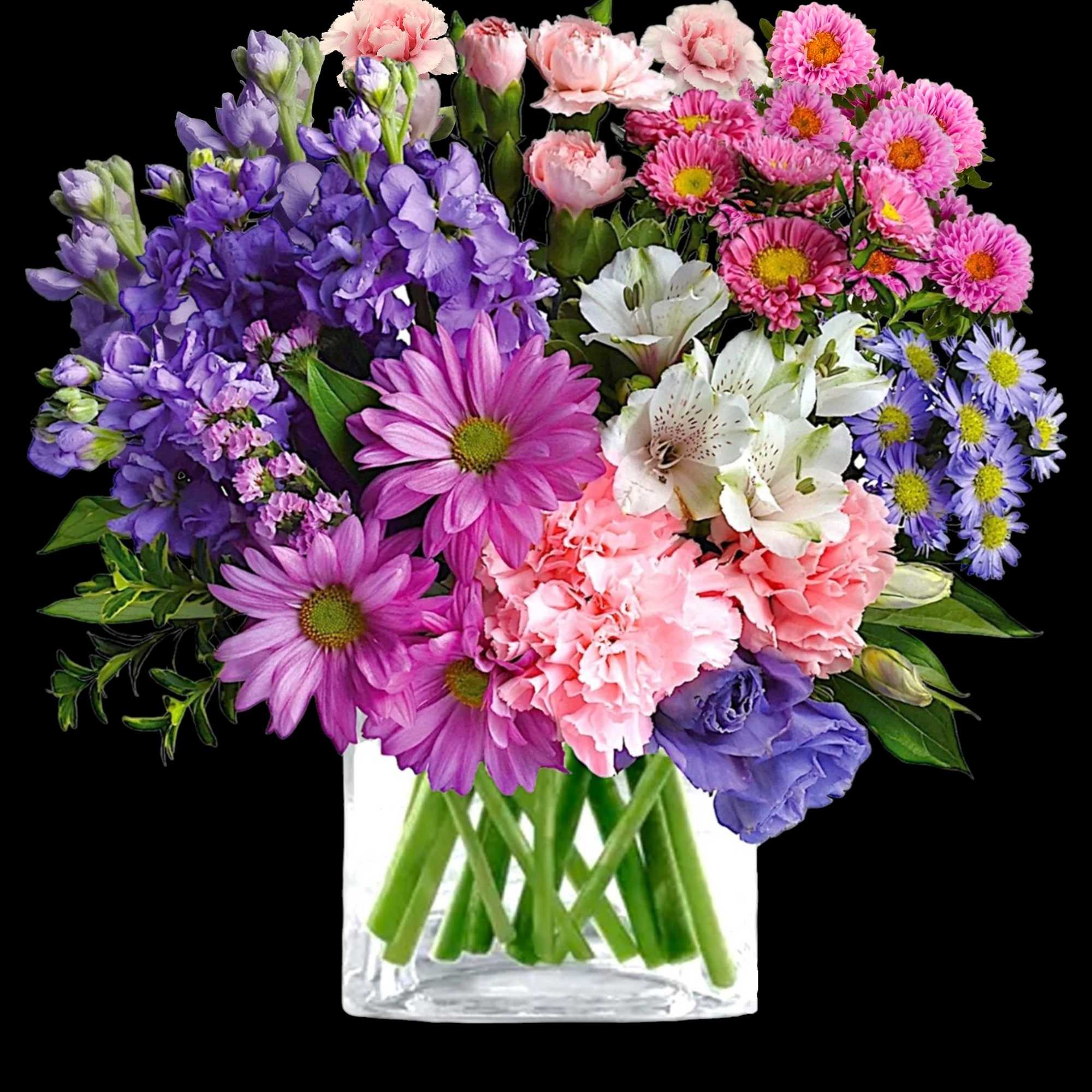 Mixed bouquet of purple, pink, white, and blue flowers in a clear vase