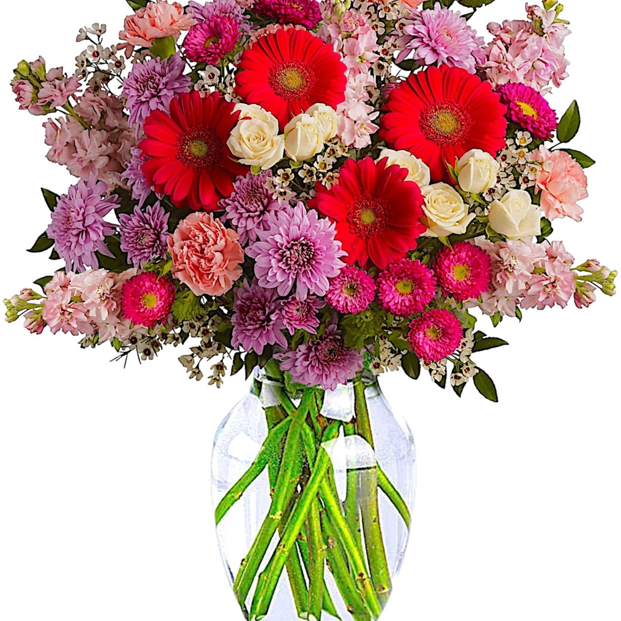 Mixed pink and red flowers arranged in a clear glass vase