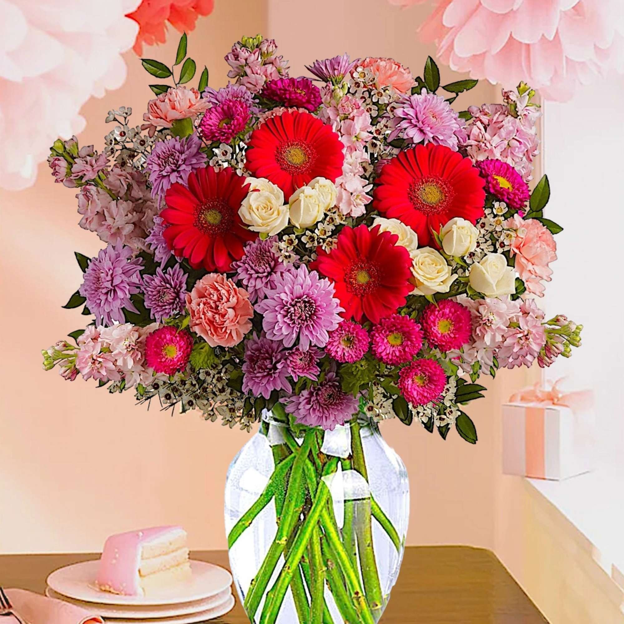 Bouquet of pink and red flowers in a clear glass vase