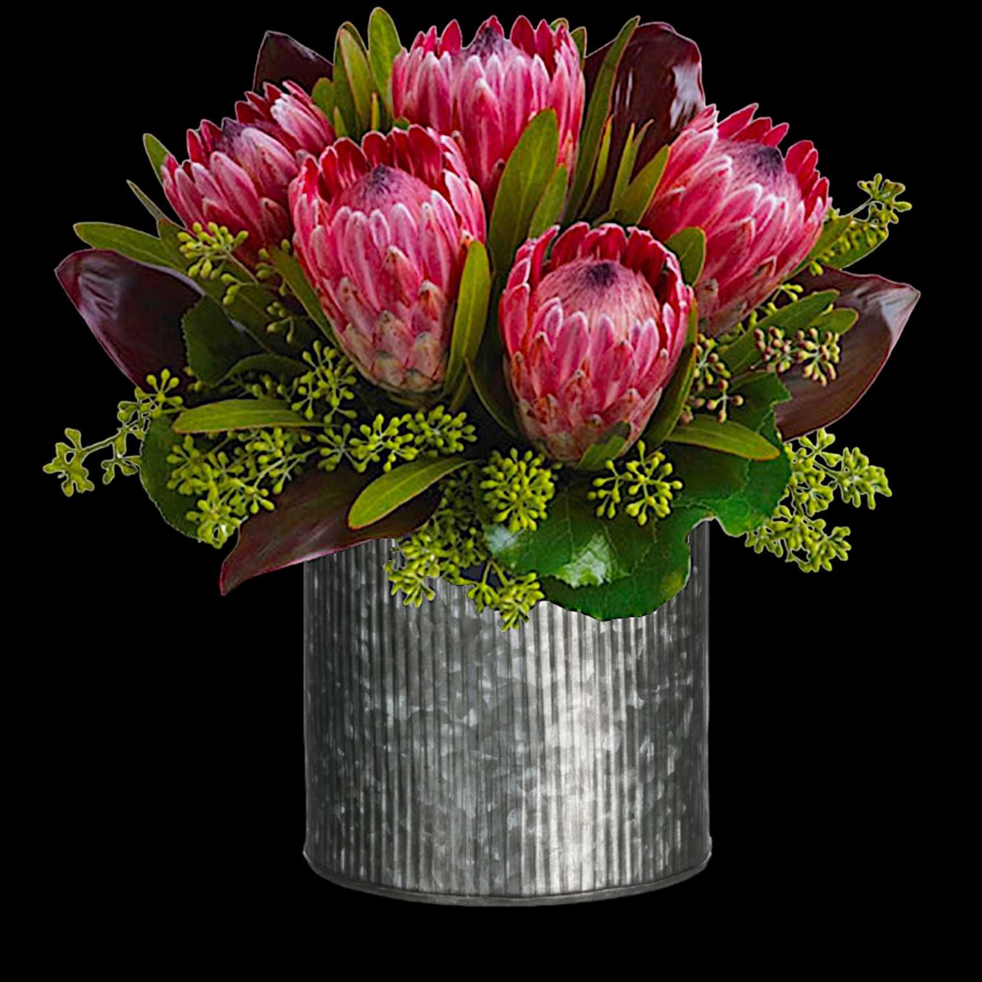 Pink protea bouquet in a ribbed silver vase