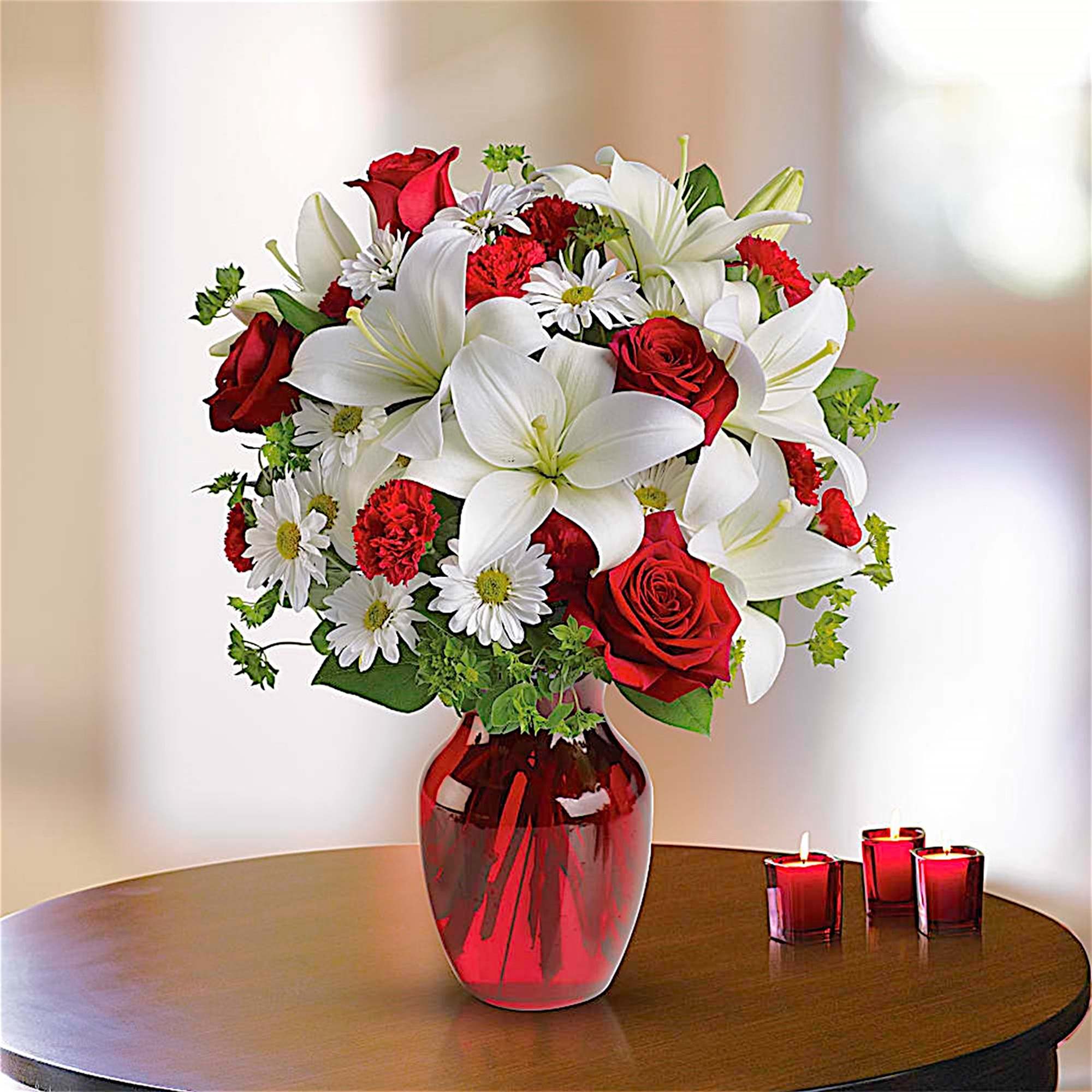 Bouquet of red roses, white lilies, and daisies in a red glass vase, photo 2 of 6