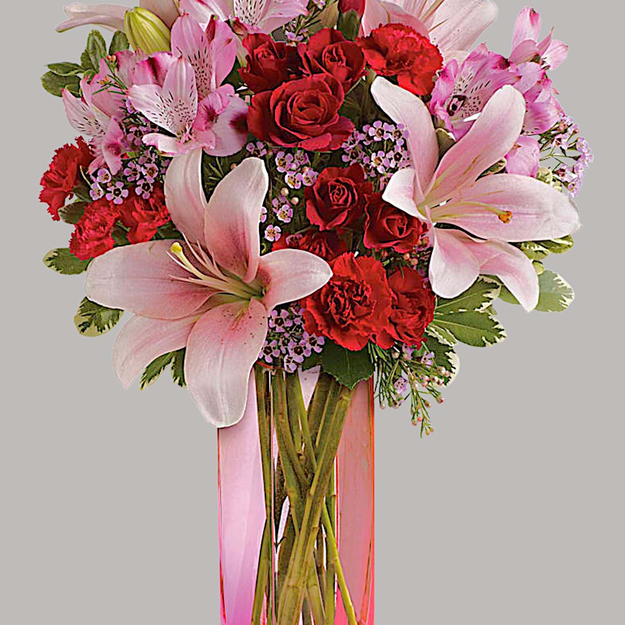 Pink lilies and red roses in a tall glass vase, photo 5 of 5