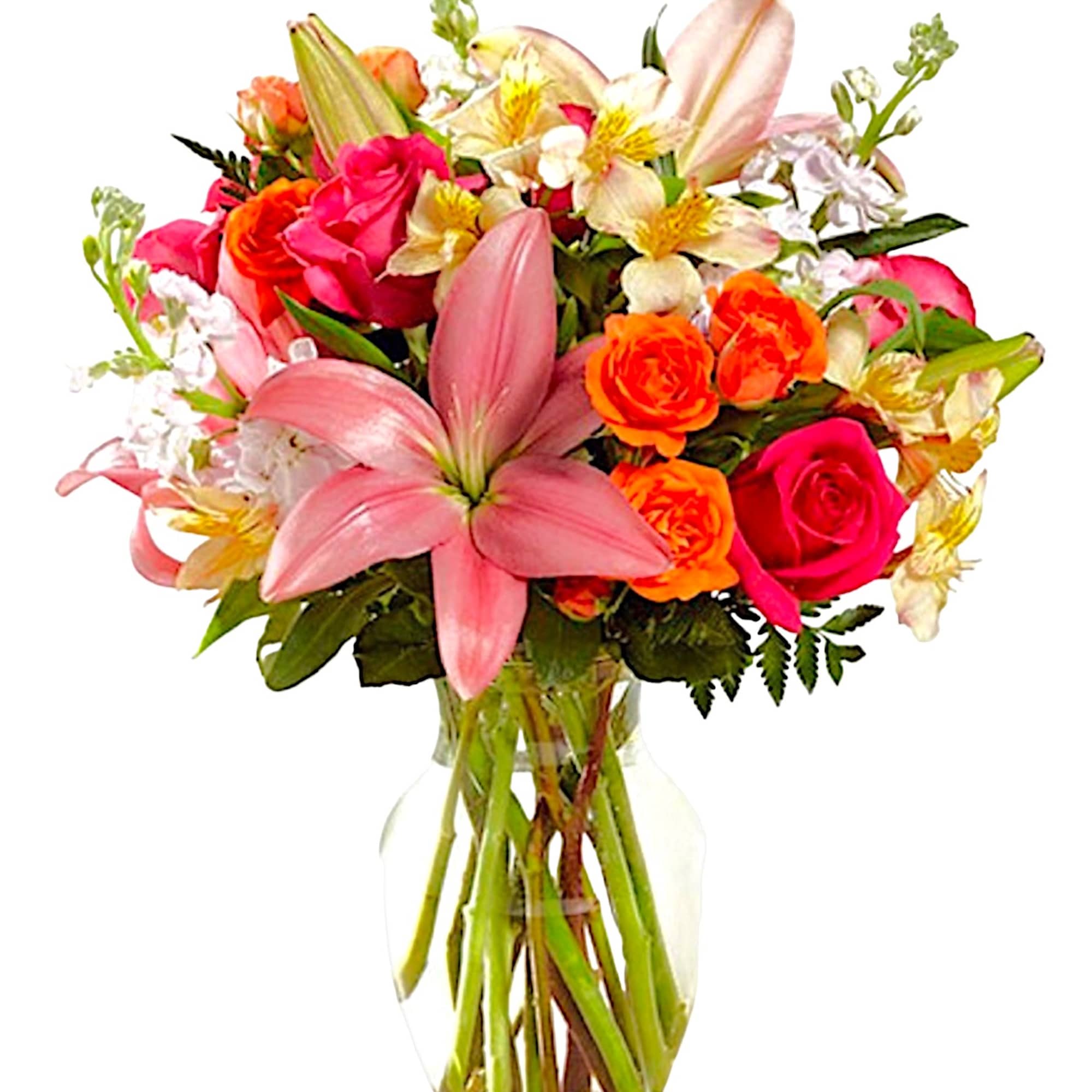 Mixed bouquet of pink lilies, roses, and orange blooms in a glass vase