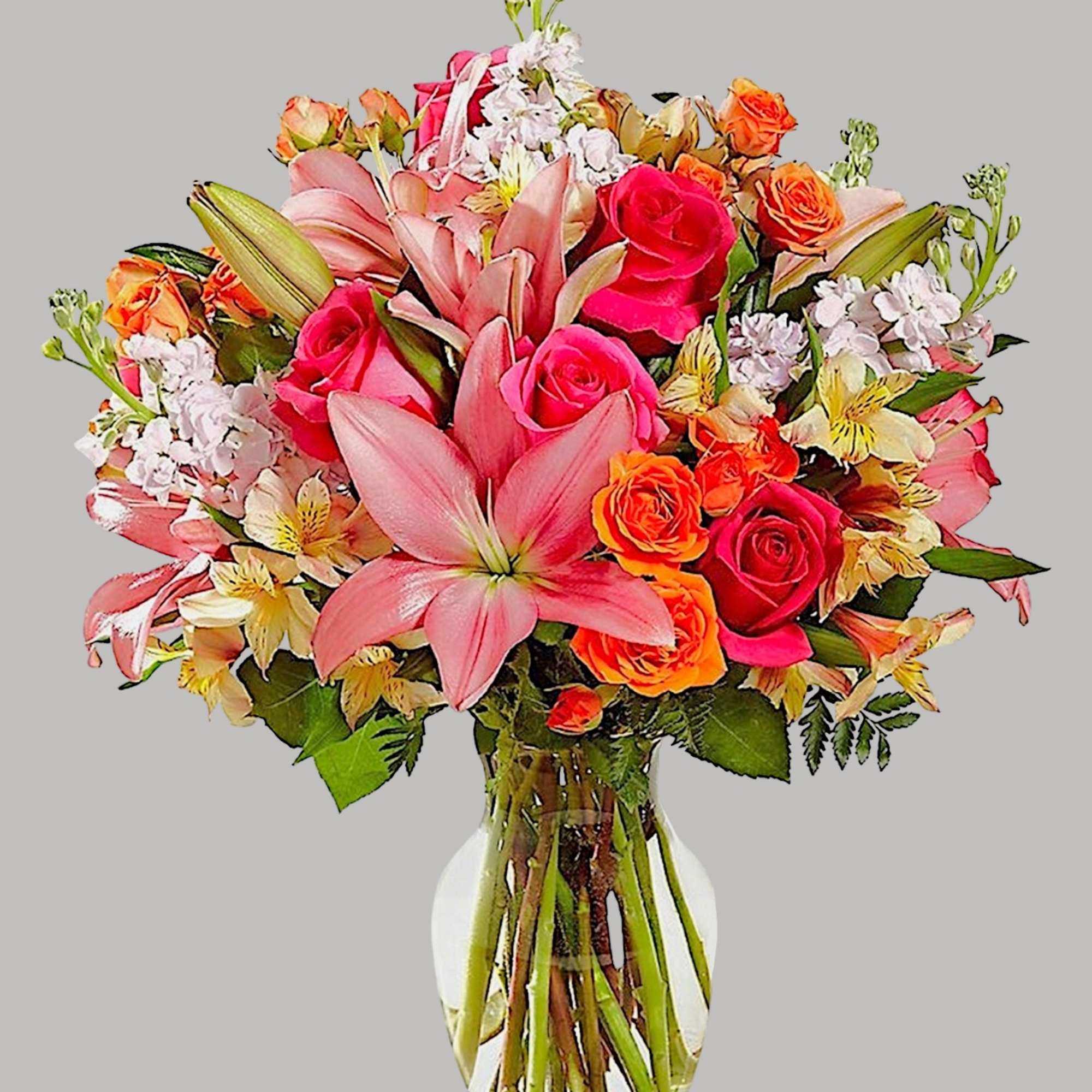Pink lilies and roses arranged in a clear glass vase, photo 13 of 13