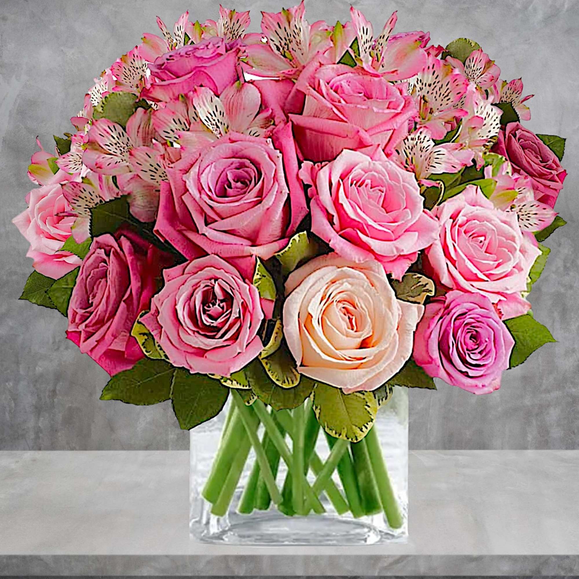 Pink roses and alstroemeria in a clear glass vase