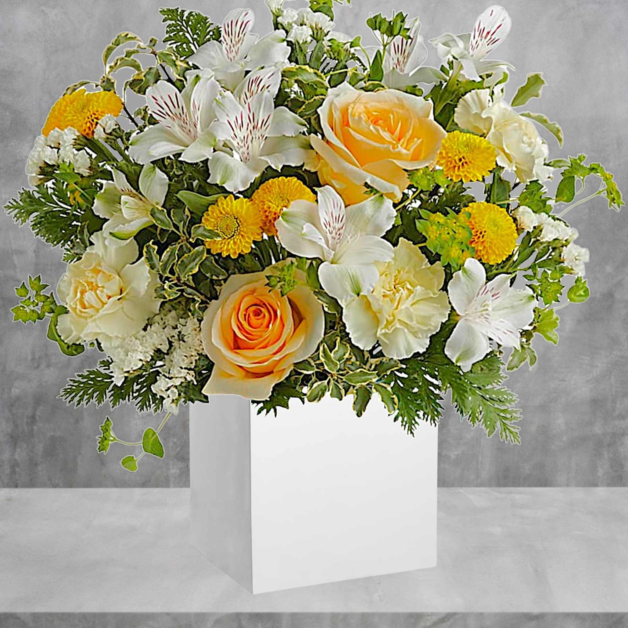 Yellow and white floral arrangement in a white box vase