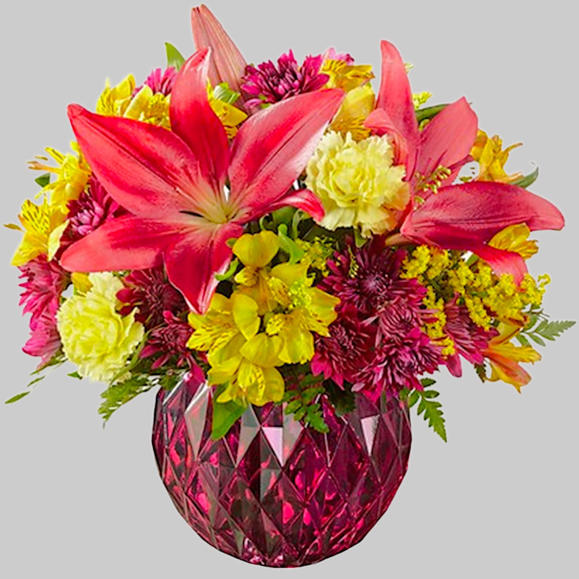 Bright mixed bouquet with pink lilies in a faceted pink vase