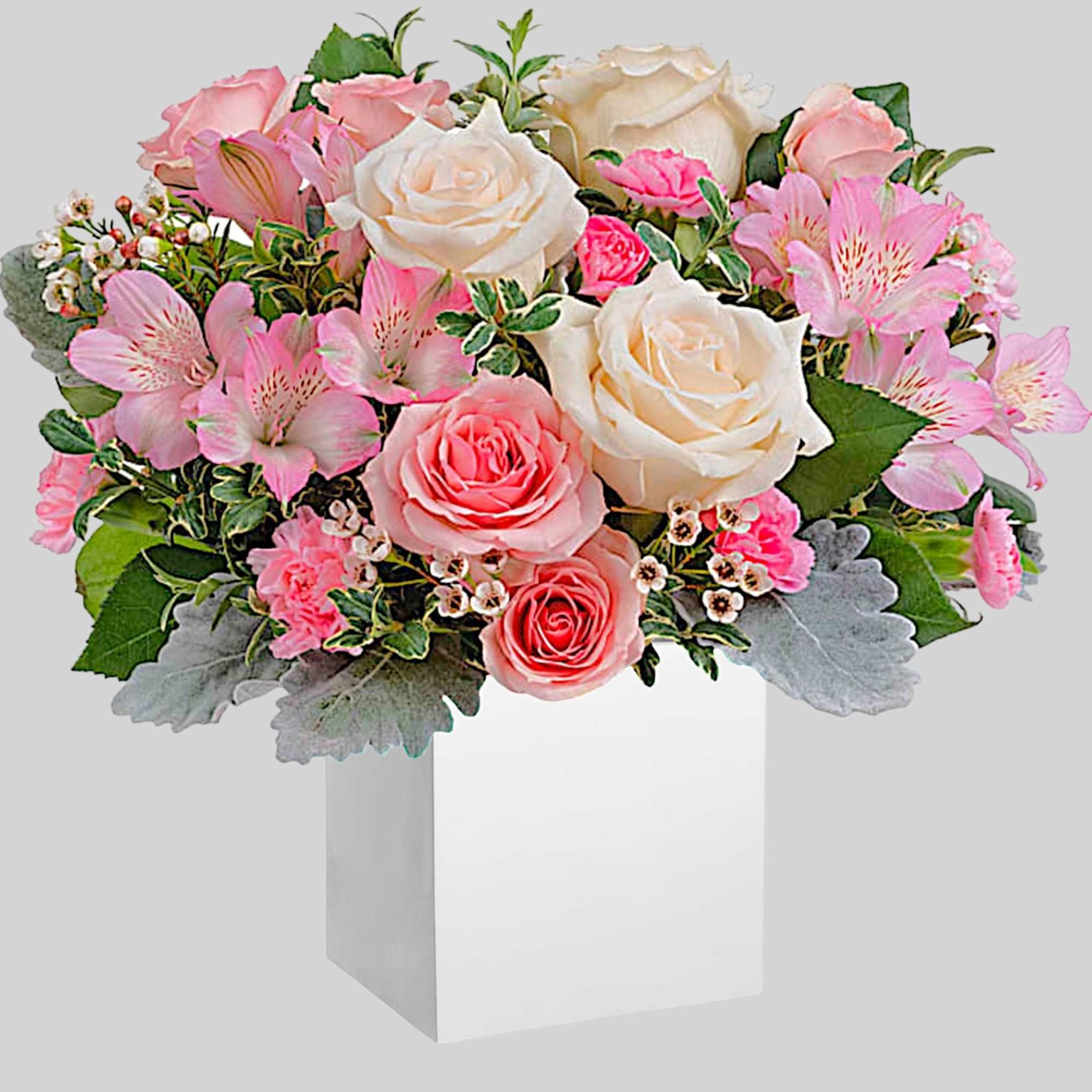 Pink and white rose bouquet with alstroemeria in a white box vase