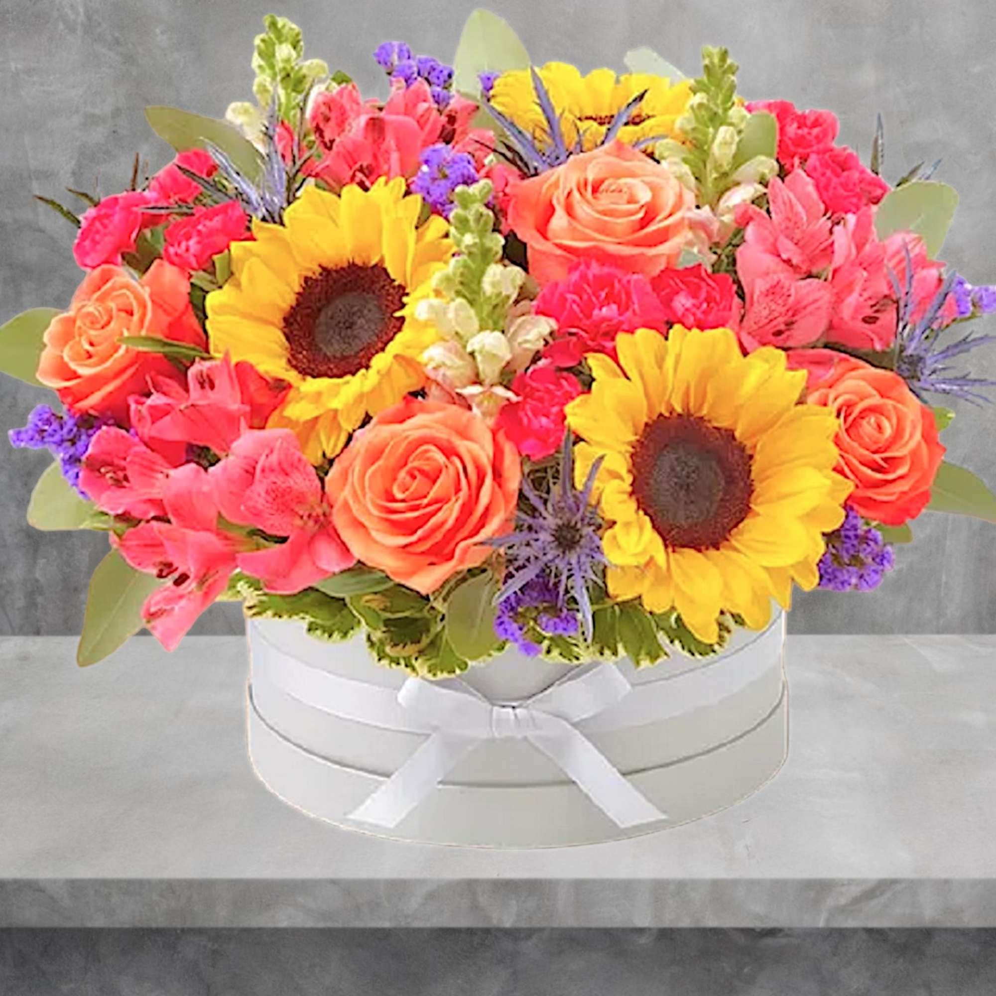 Bright mixed bouquet in a white round box with a ribbon, photo 9 of 11