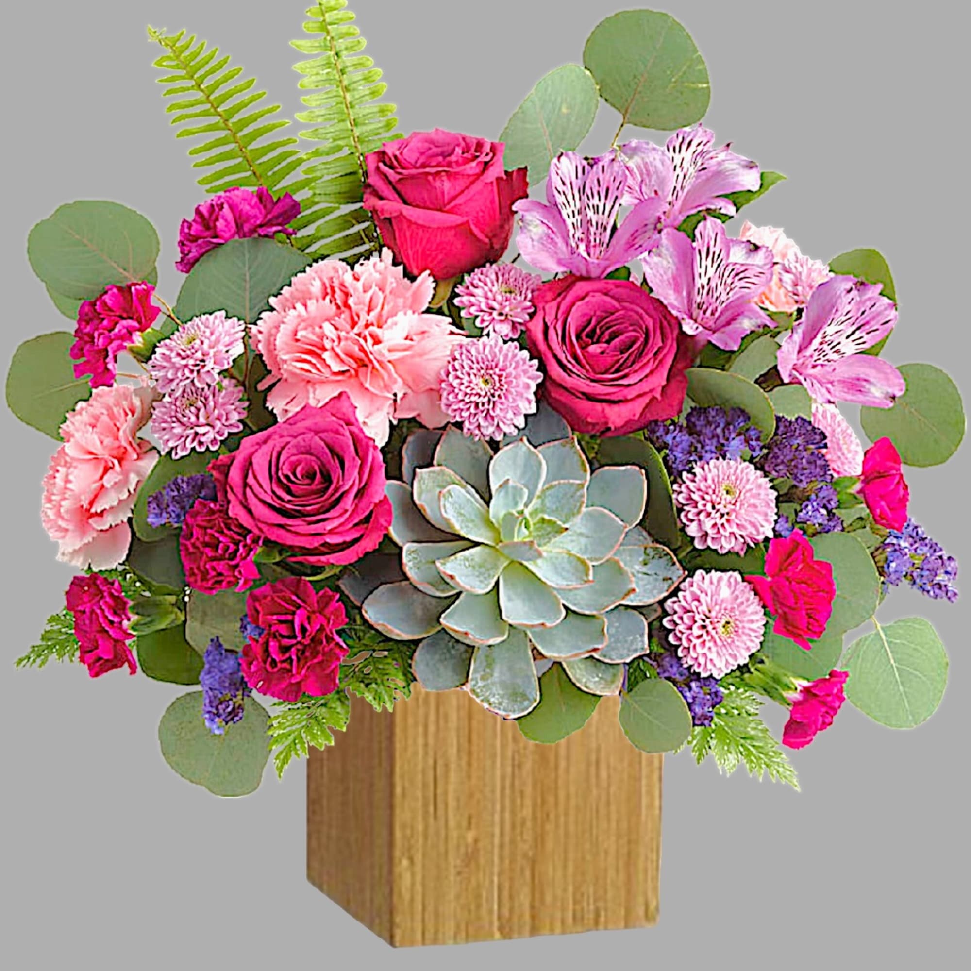 Pink roses and carnations with a succulent in a wooden cube vase