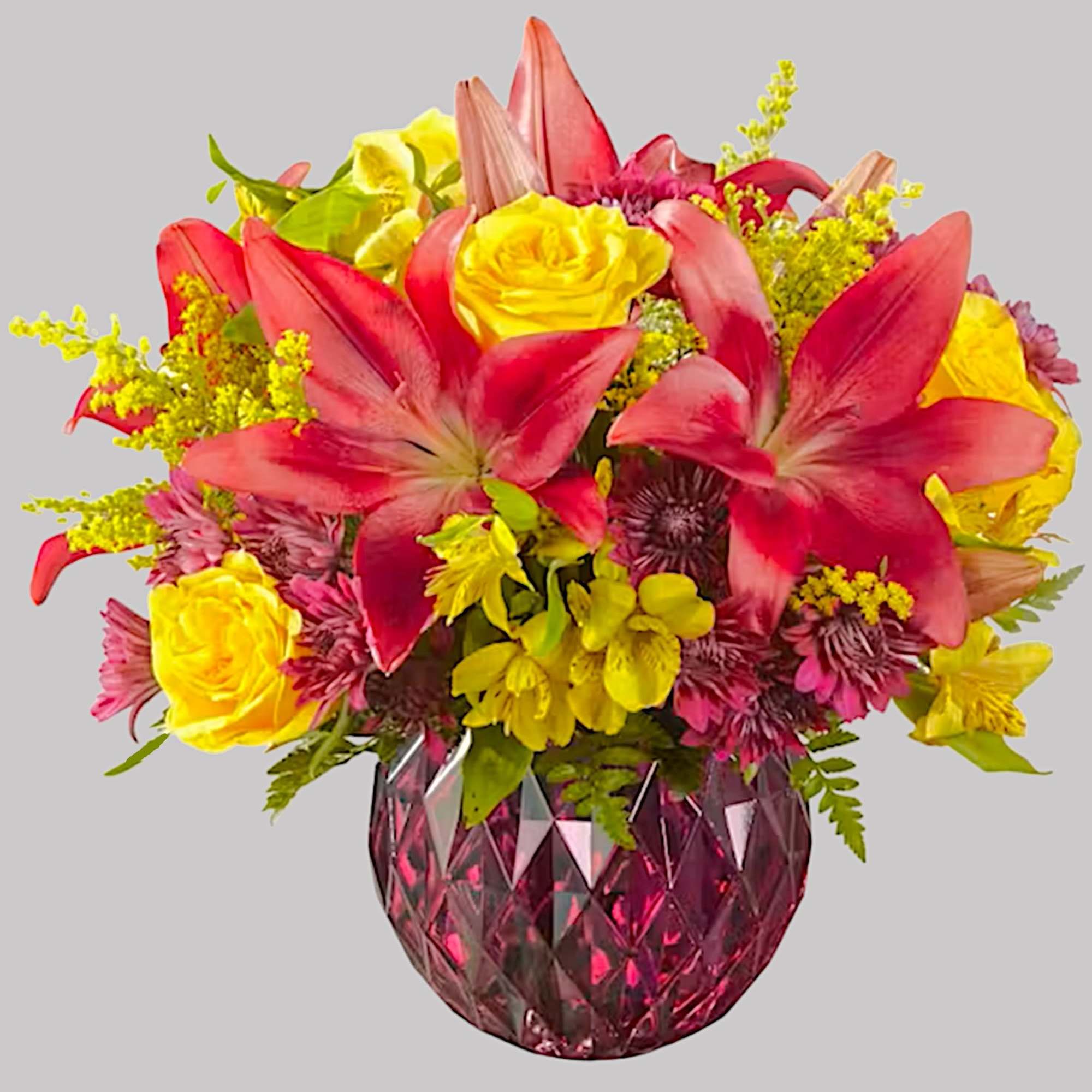 Bright bouquet of pink lilies and yellow roses in a faceted pink vase