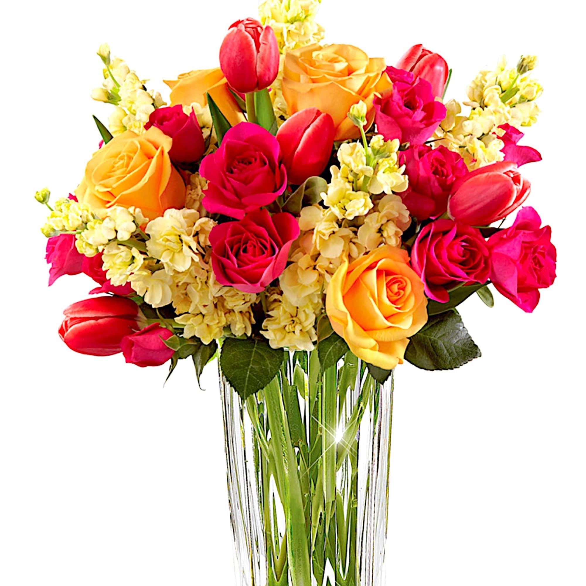 Bouquet of pink and yellow roses with tulips in a clear glass vase