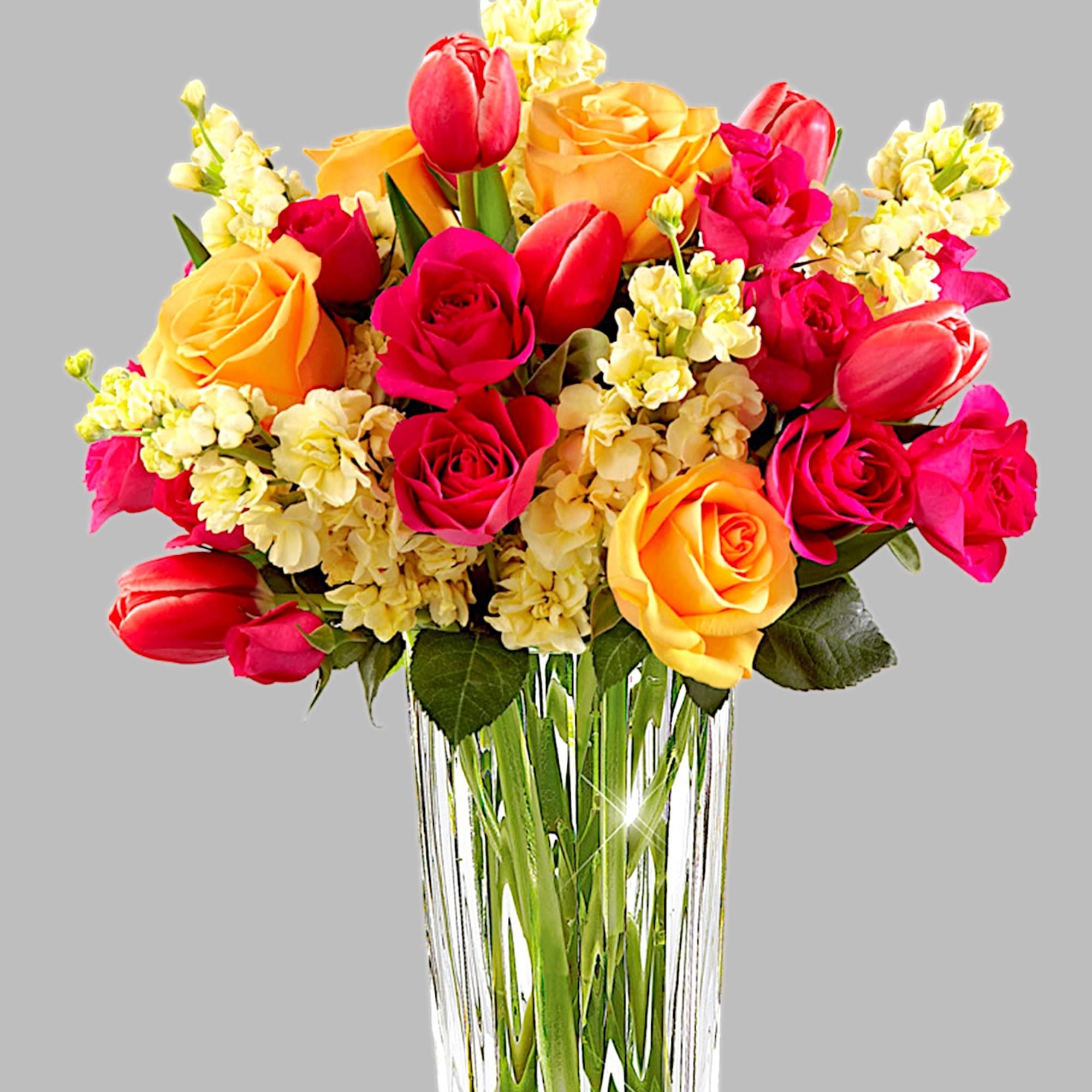 Bouquet of pink and yellow roses with tulips in a clear glass vase, photo 4 of 4