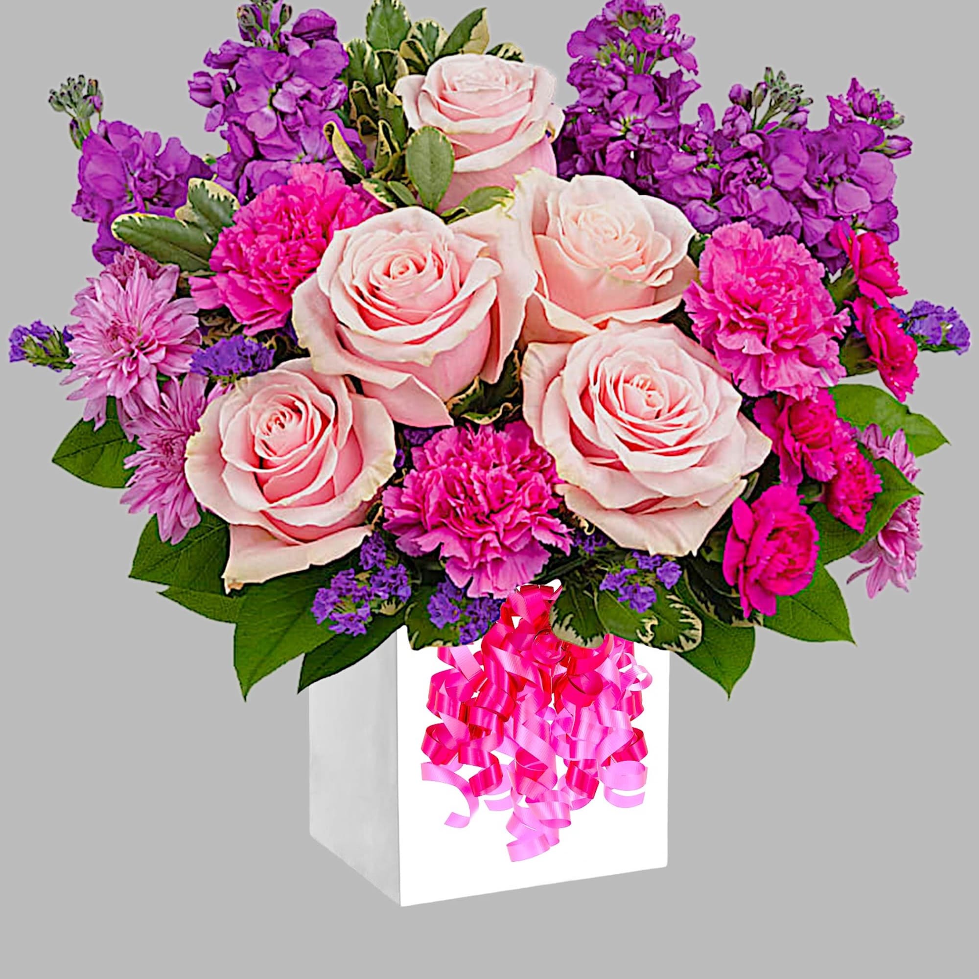 Pink roses and purple flowers in a white gift box with a ribbon bow