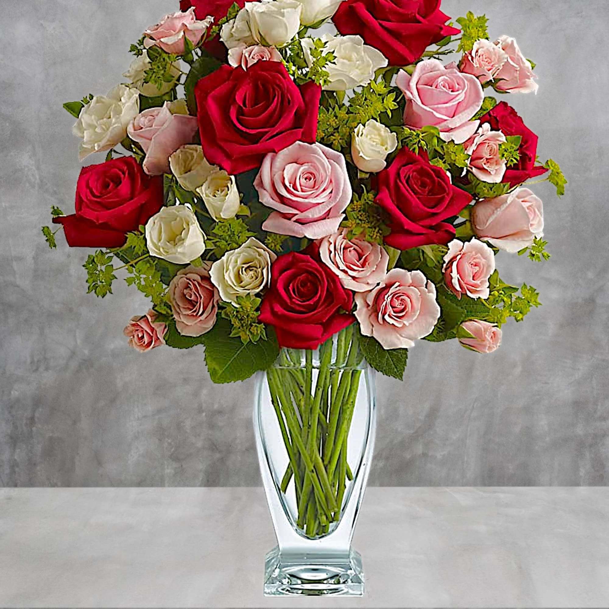 Bouquet of red, pink, and white roses in a clear glass vase, photo 3 of 5