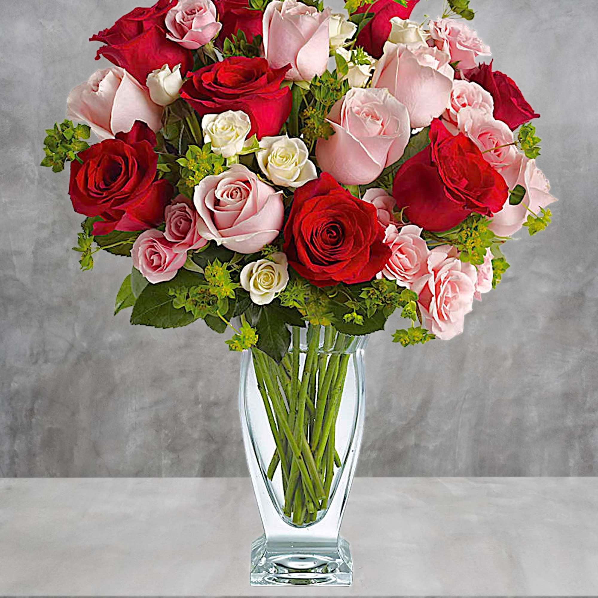 Bouquet of red, pink, and white roses in a clear glass vase, photo 5 of 7
