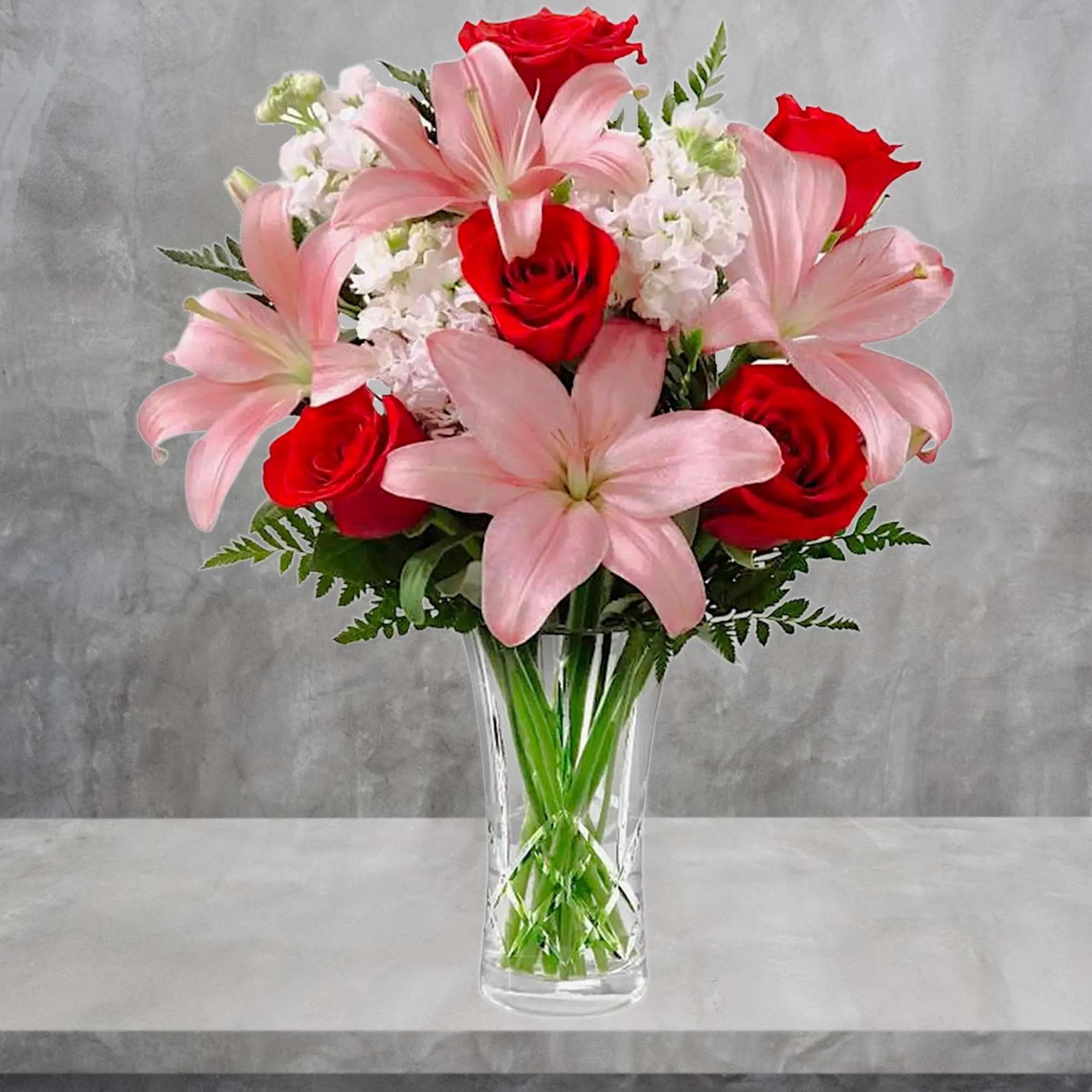 Bouquet of pink lilies and red roses in a clear glass vase, photo 2 of 4