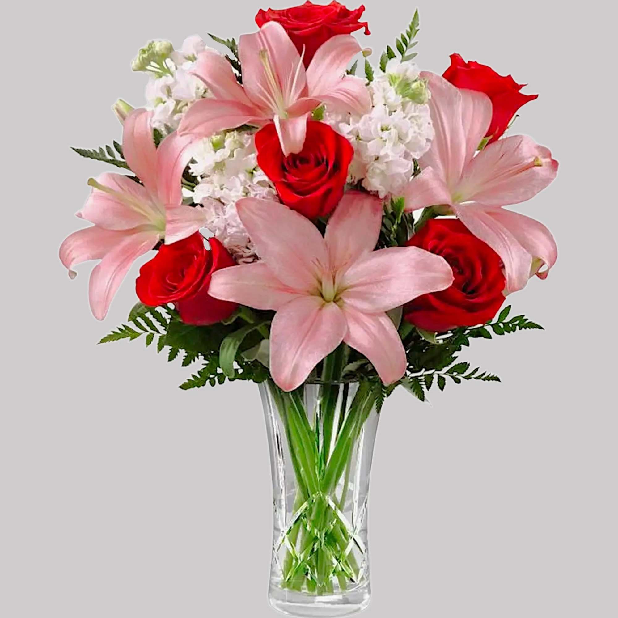 Pink lilies and red roses in a clear glass vase, photo 4 of 4
