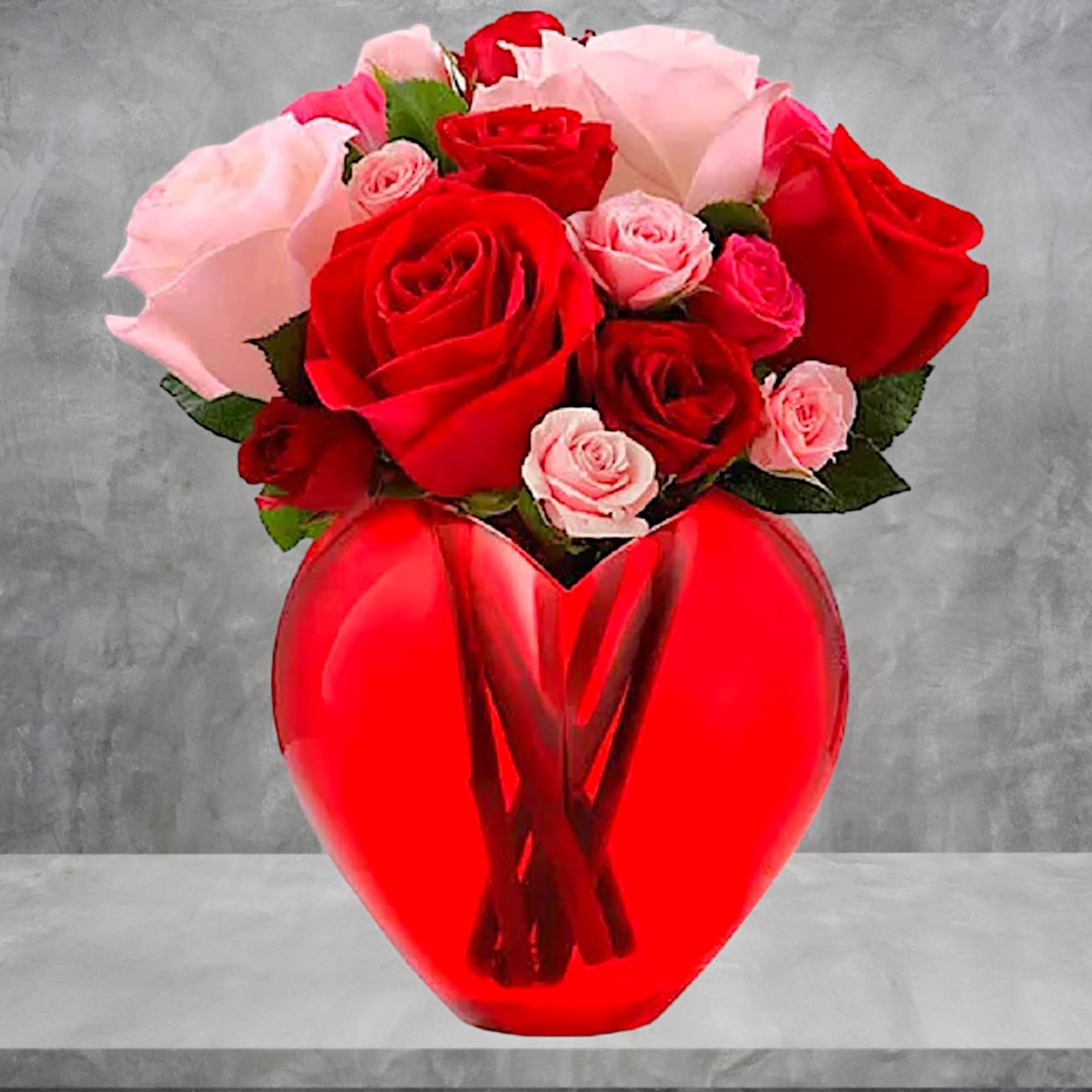 Red and pink roses in a red heart-shaped vase