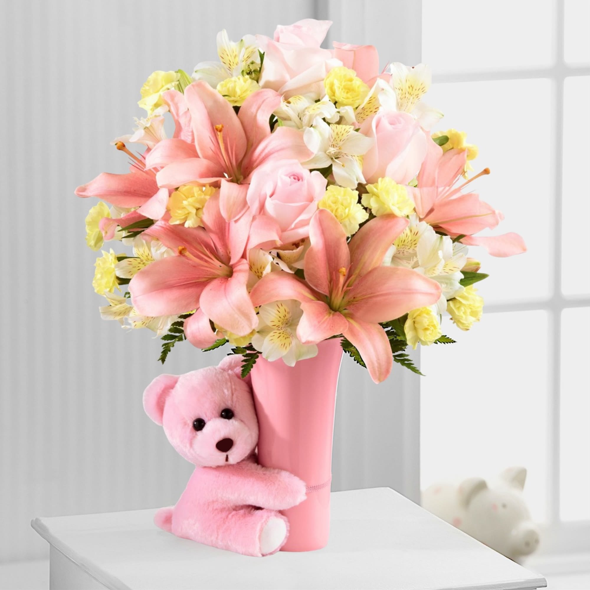 Pink and yellow flower arrangement in a pink vase with a teddy bear, photo 2 of 5