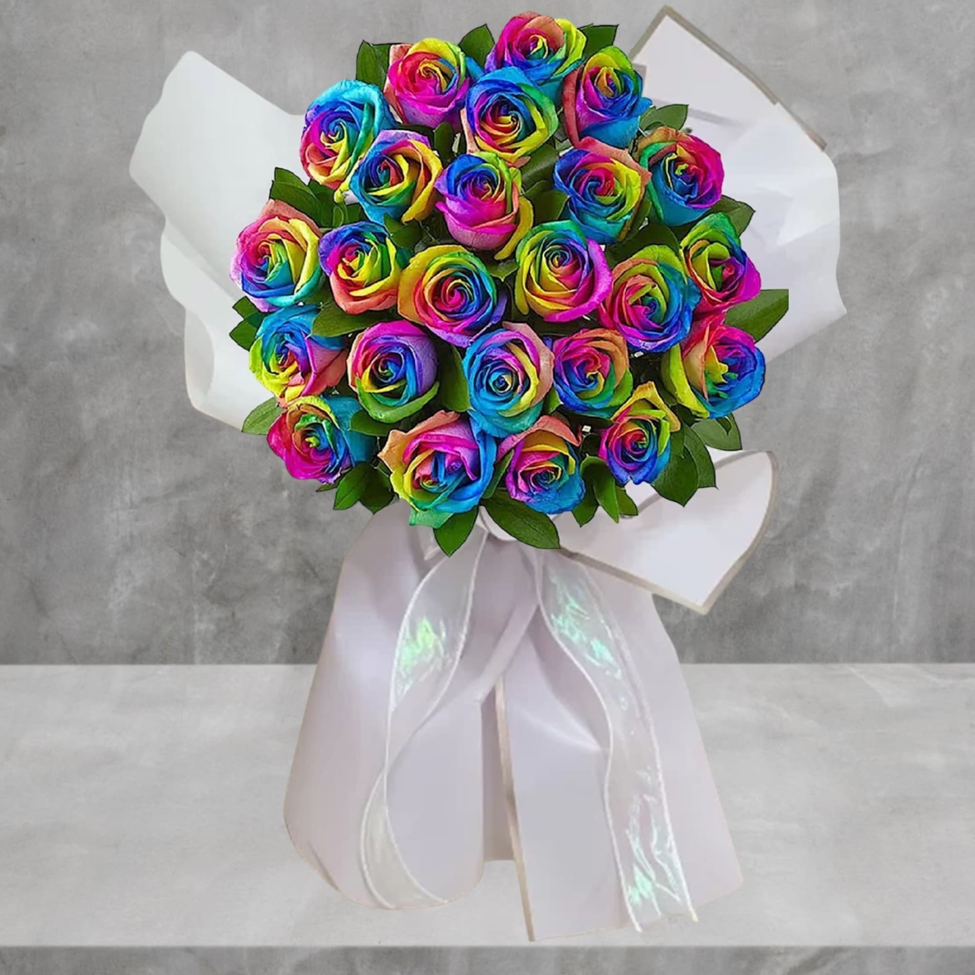 Bouquet of rainbow-colored roses wrapped in white paper with a ribbon, photo 2 of 4