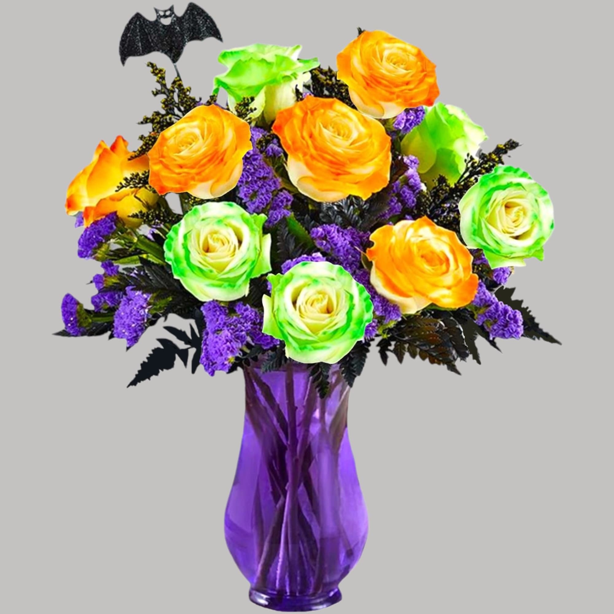 Orange and green roses in a purple vase with a small bat decoration