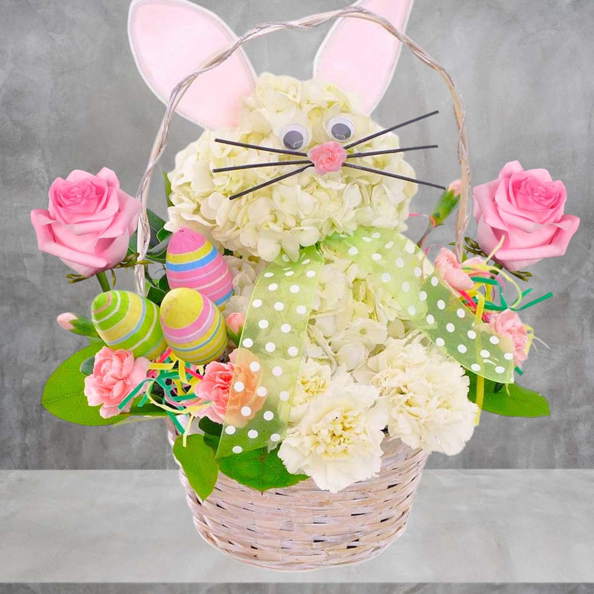 Basket arrangement shaped like a bunny with pink ears and roses