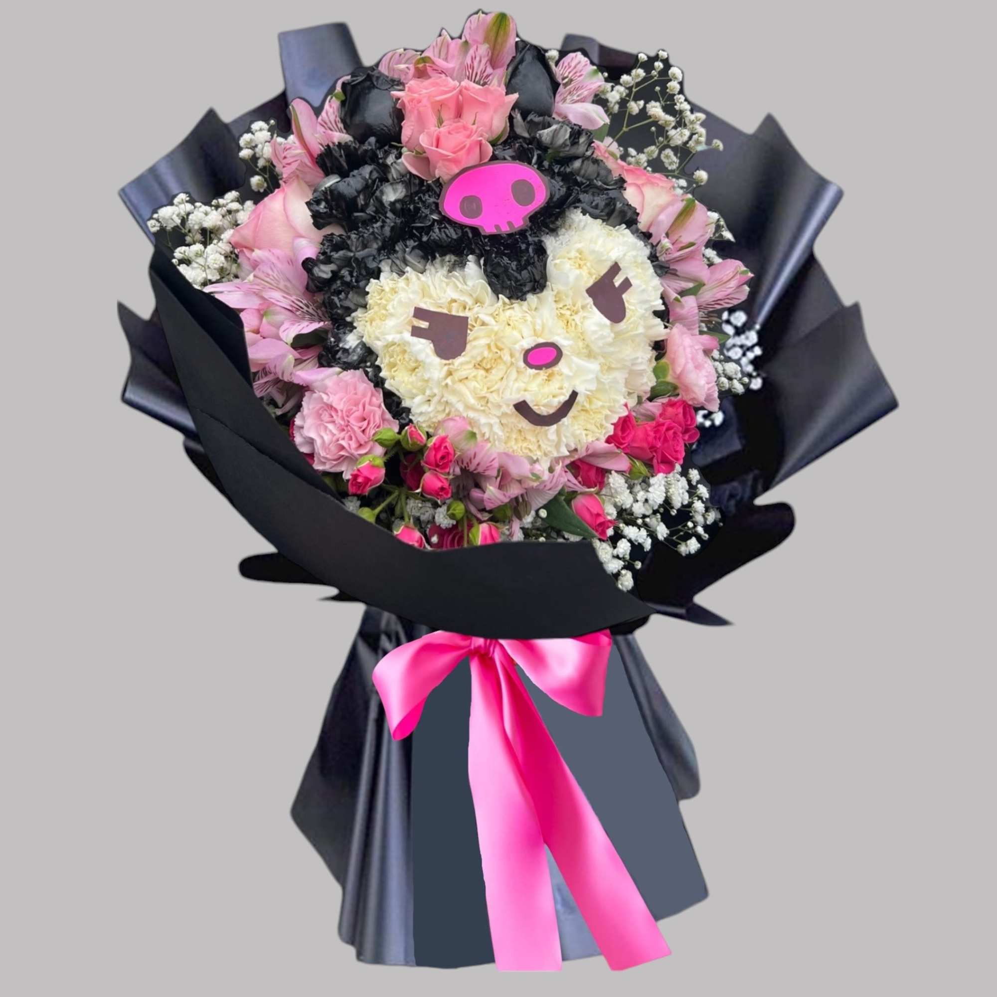 Bouquet shaped like a cartoon face with pink and black flowers and a pink ribbon