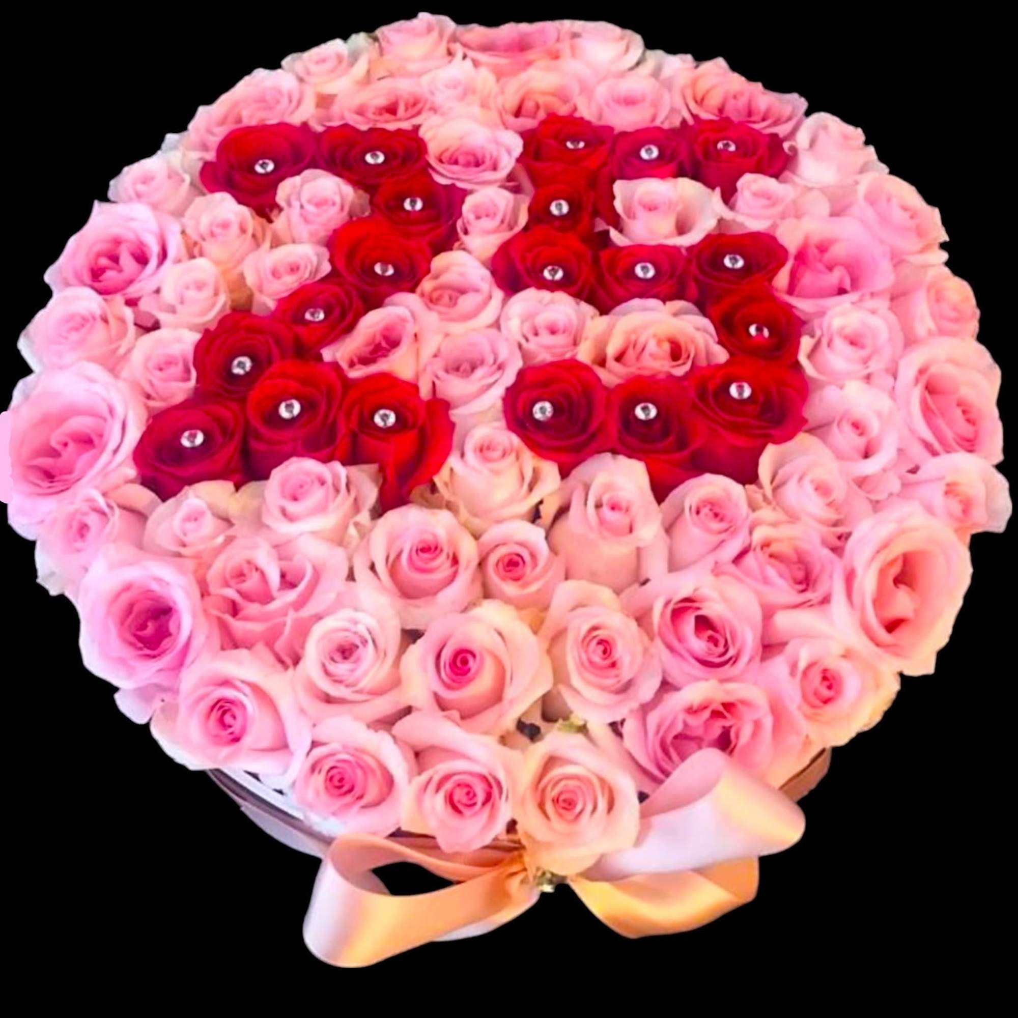 Heart-shaped bouquet of pink and red roses with a satin ribbon