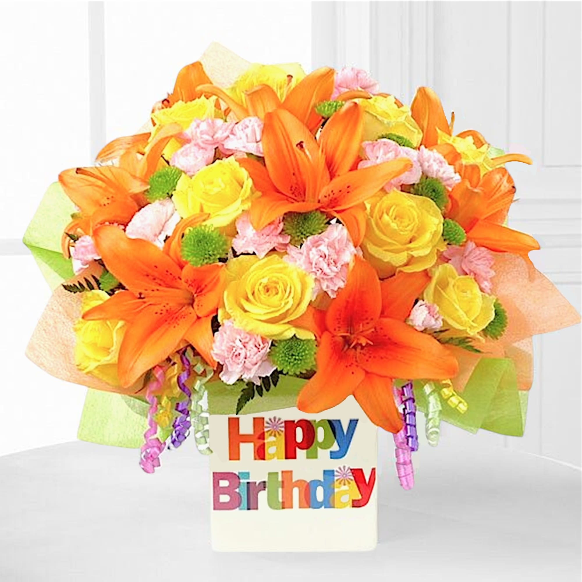 Orange lilies and yellow roses in a birthday container
