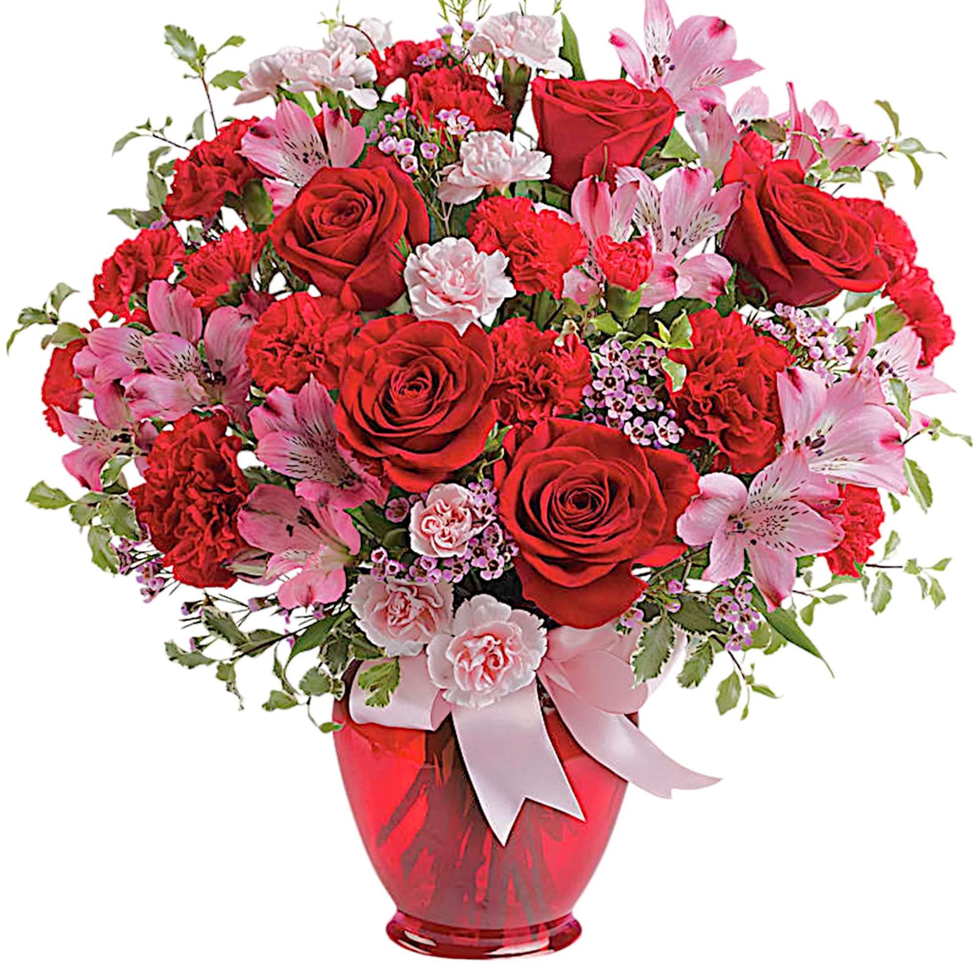Red roses and pink flowers arranged in a red glass vase with a ribbon