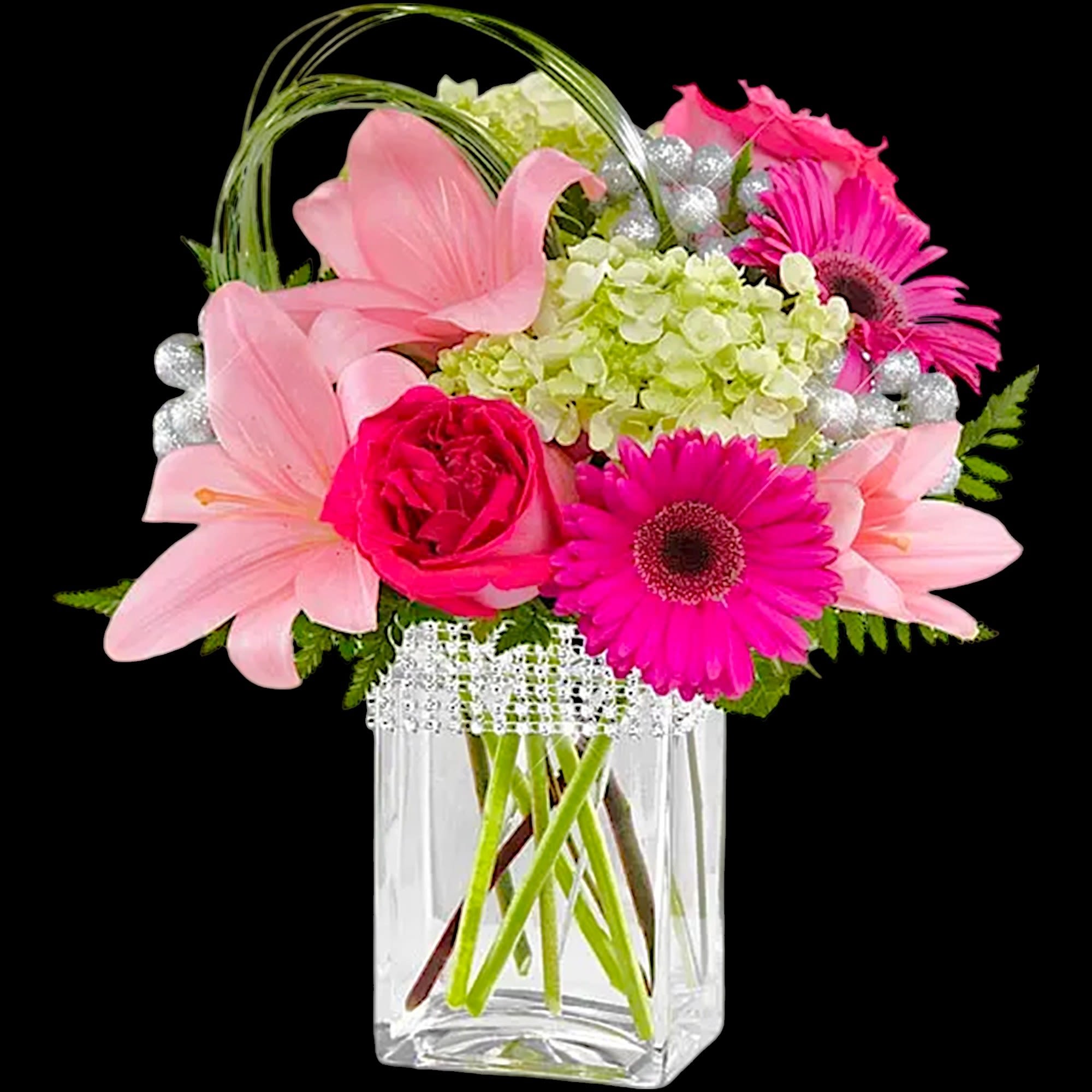 Pink lilies, gerbera daisies, and roses in a clear square vase