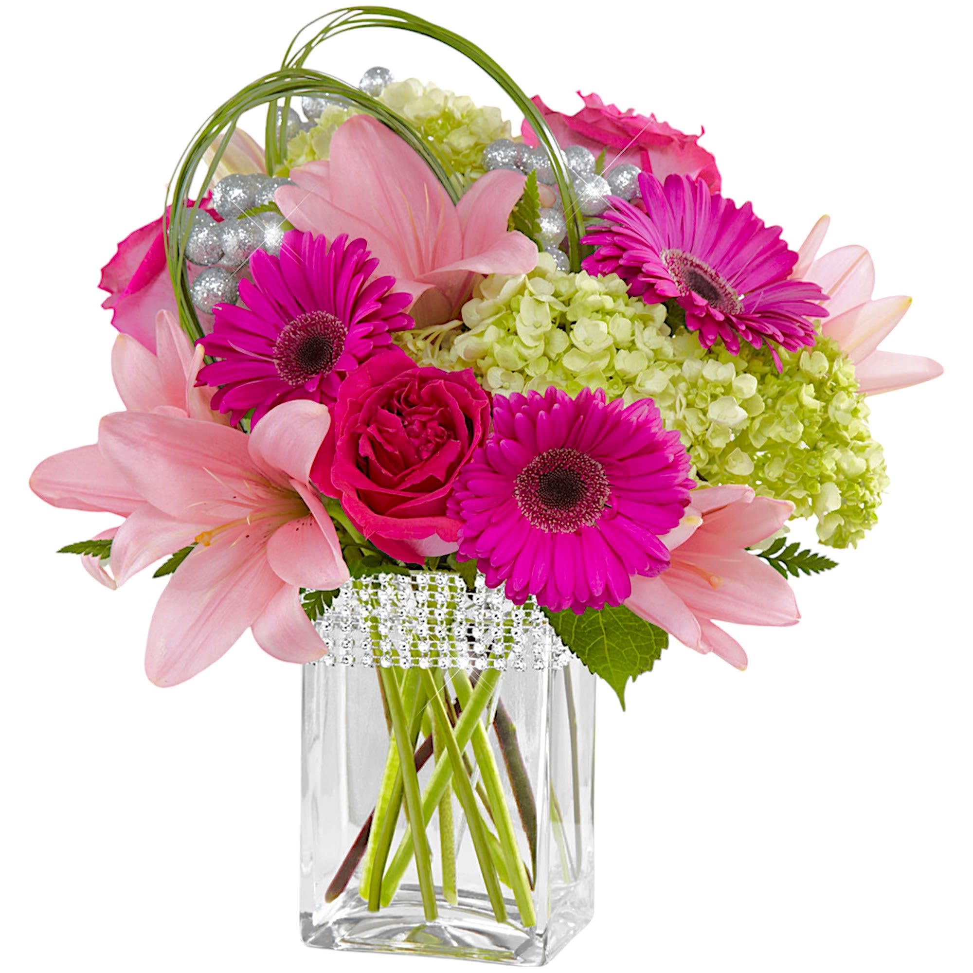 Pink and magenta flowers arranged in a clear square vase