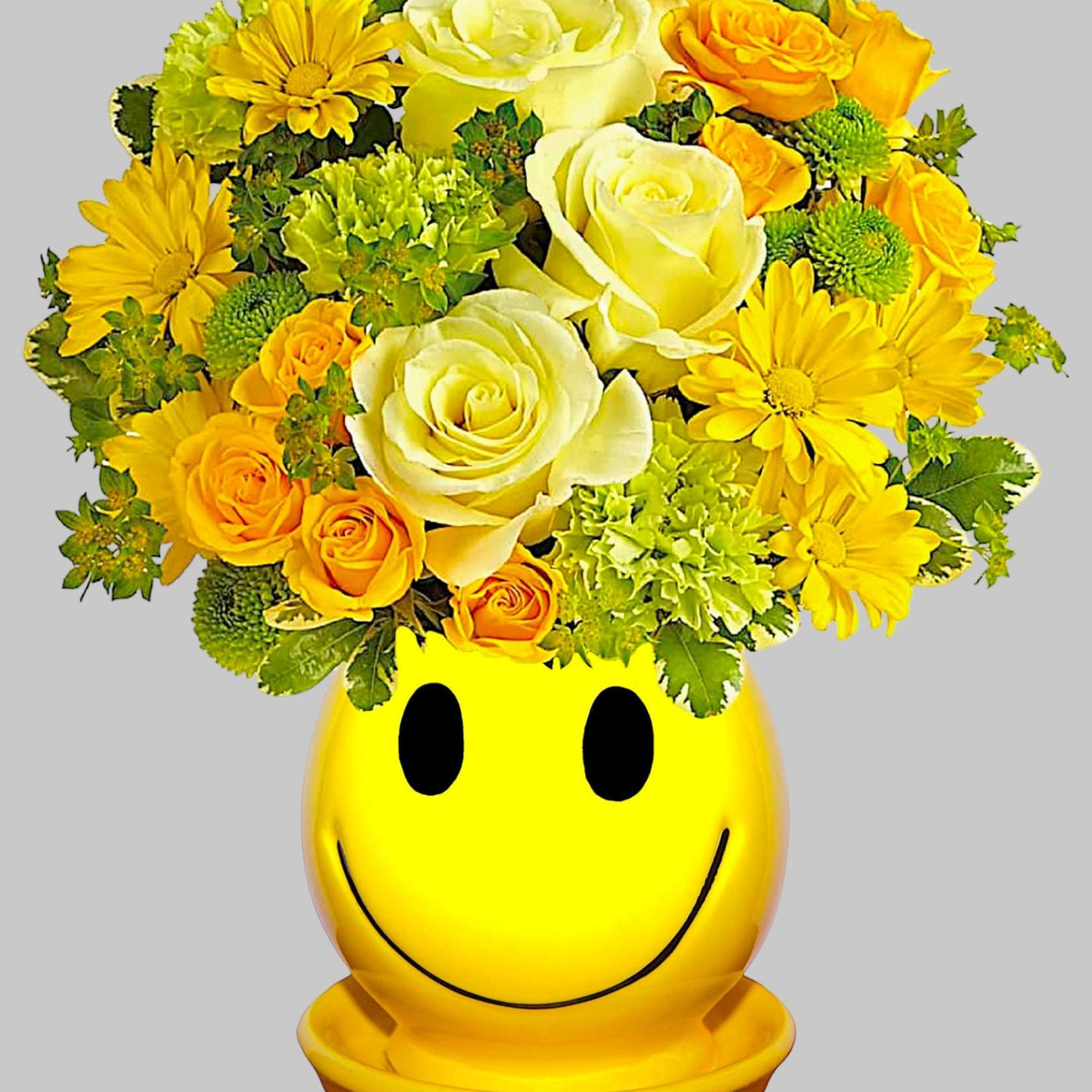 Yellow and white flower arrangement in a smiley-face pot