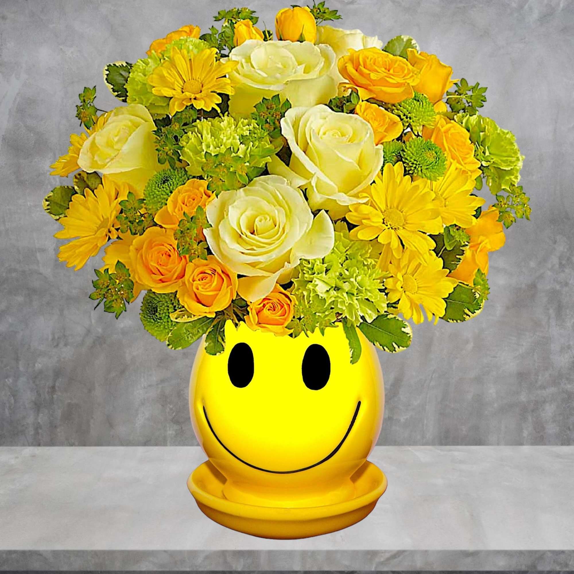 Yellow and white flower arrangement in a smiley-face pot