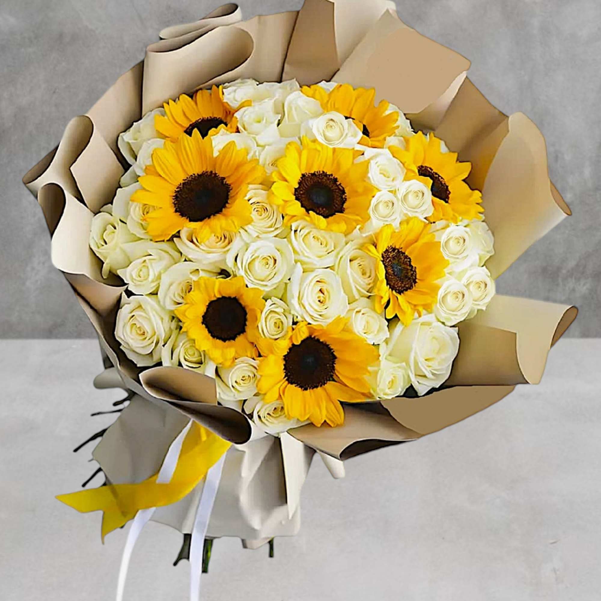 Bouquet of yellow sunflowers and white roses wrapped in tan paper, photo 2 of 4