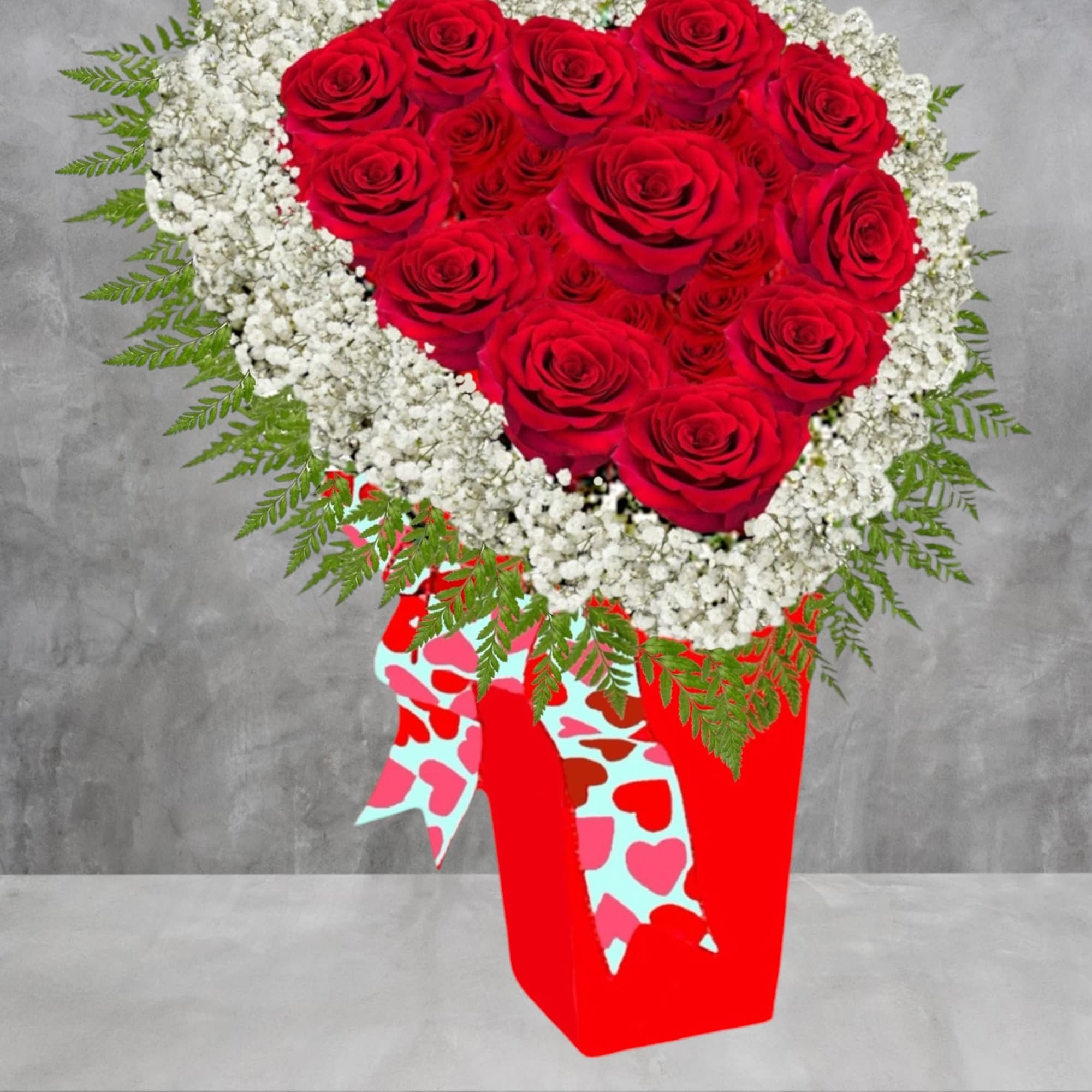 Heart-shaped bouquet of red roses edged with white baby's breath