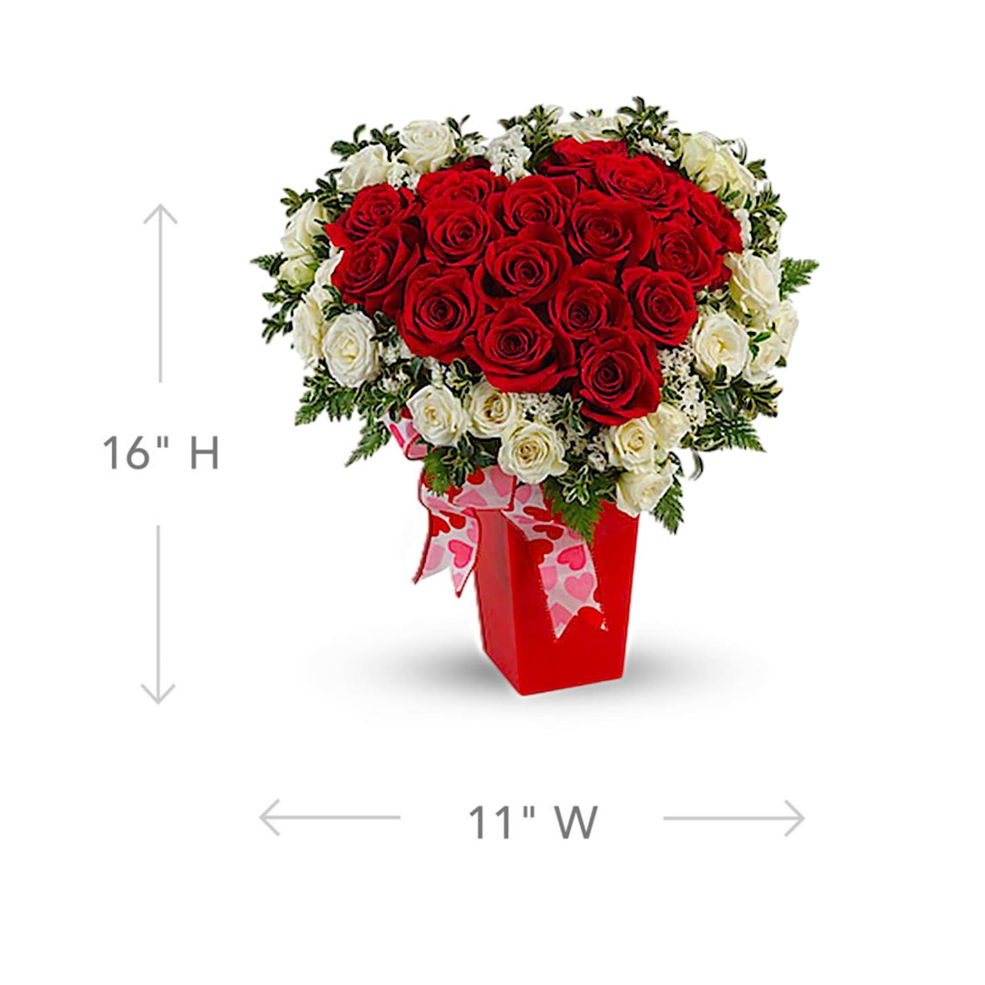 Heart-shaped bouquet of red and white roses in a red vase