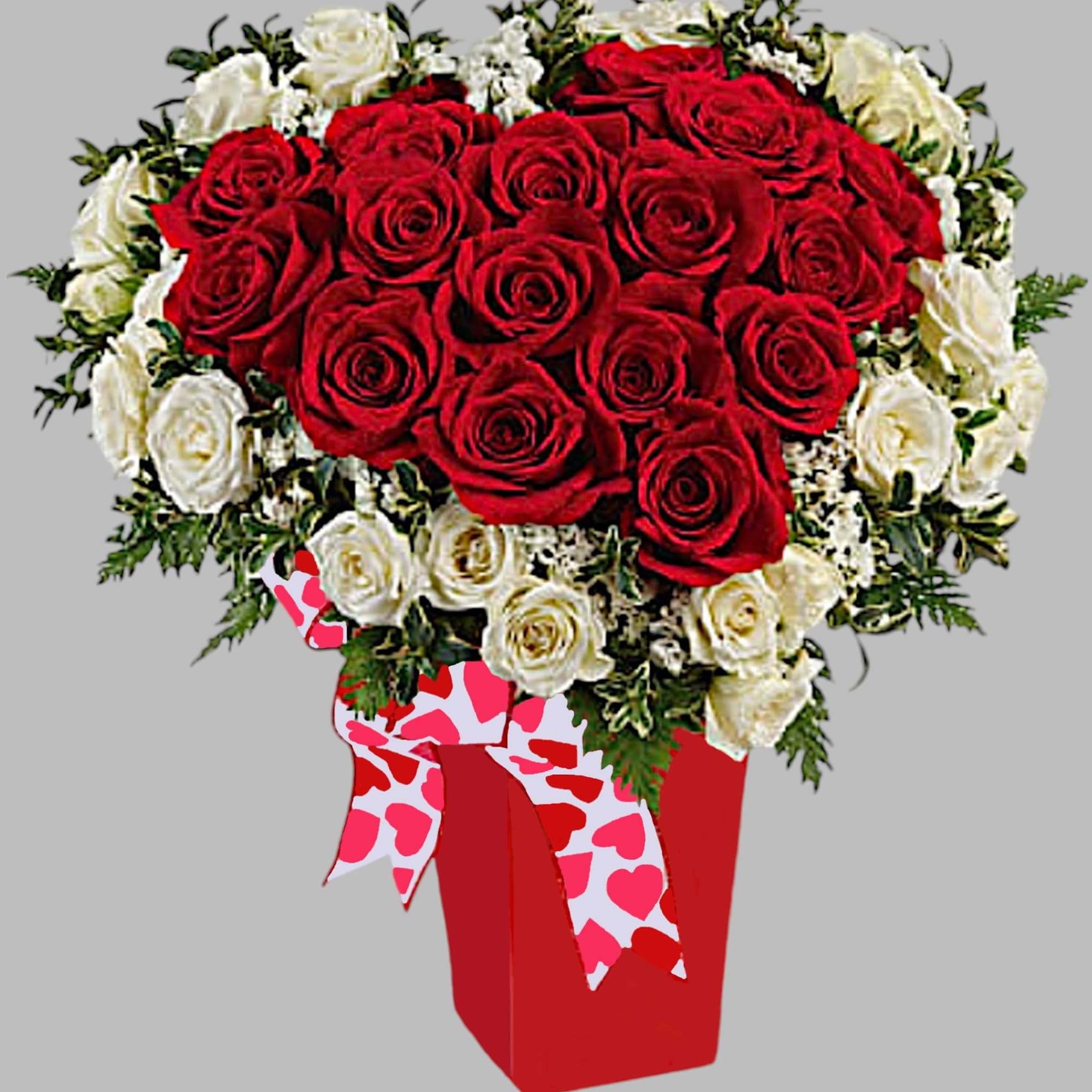 Heart-shaped bouquet of red and white roses in a red box with heart ribbon