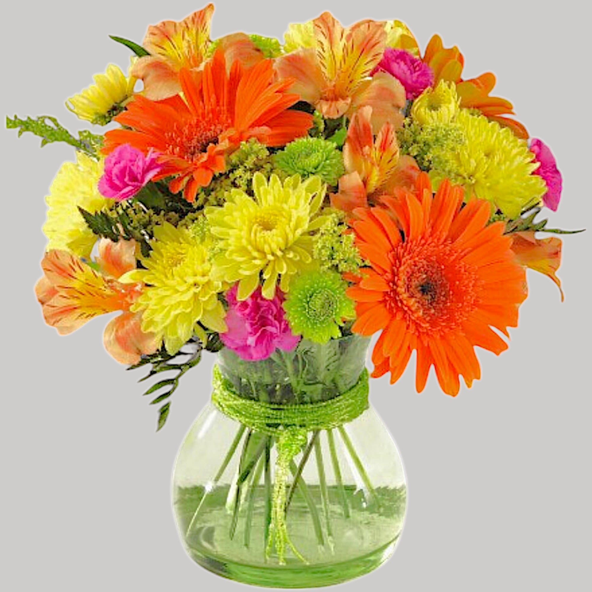 Bright mixed bouquet in a clear glass vase with orange, yellow, and pink flowers