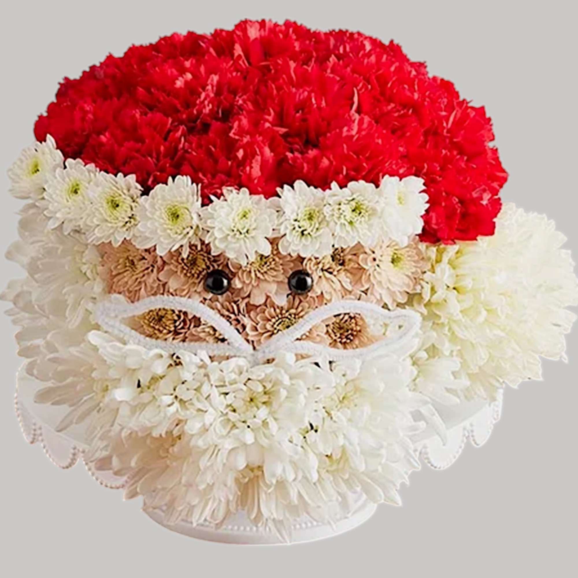 Flower arrangement shaped like Santa Claus with red and white blooms