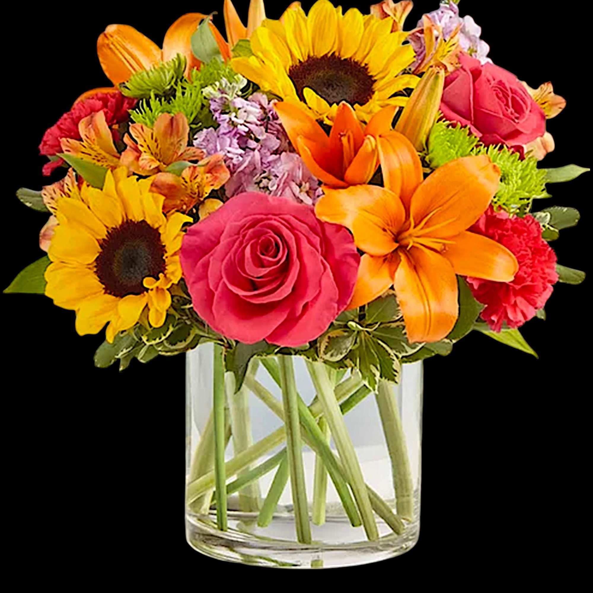 Bright mixed bouquet with sunflowers, roses, lilies, and a clear glass vase