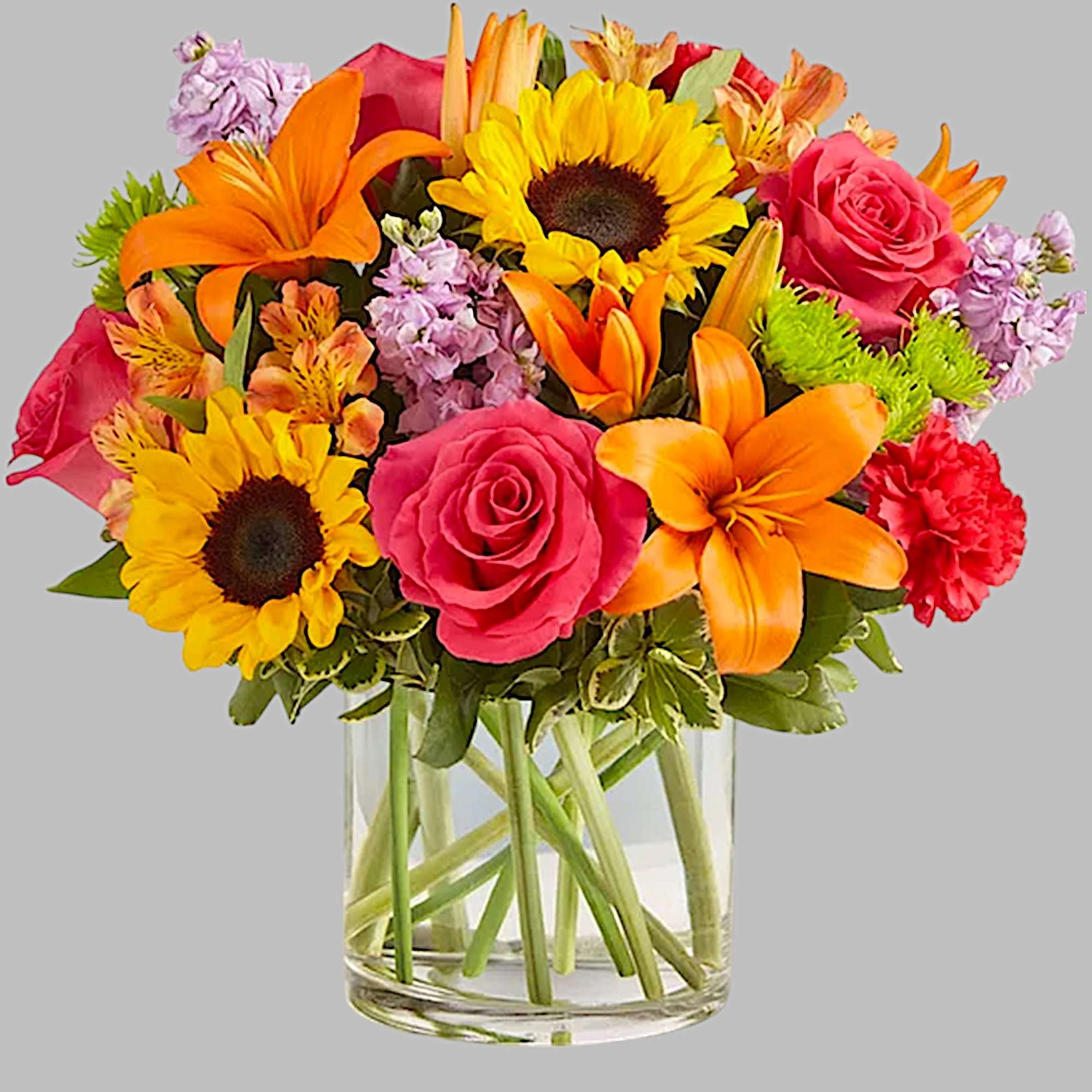 Mixed bouquet of sunflowers, roses, lilies, and carnations in a glass vase, photo 6 of 6