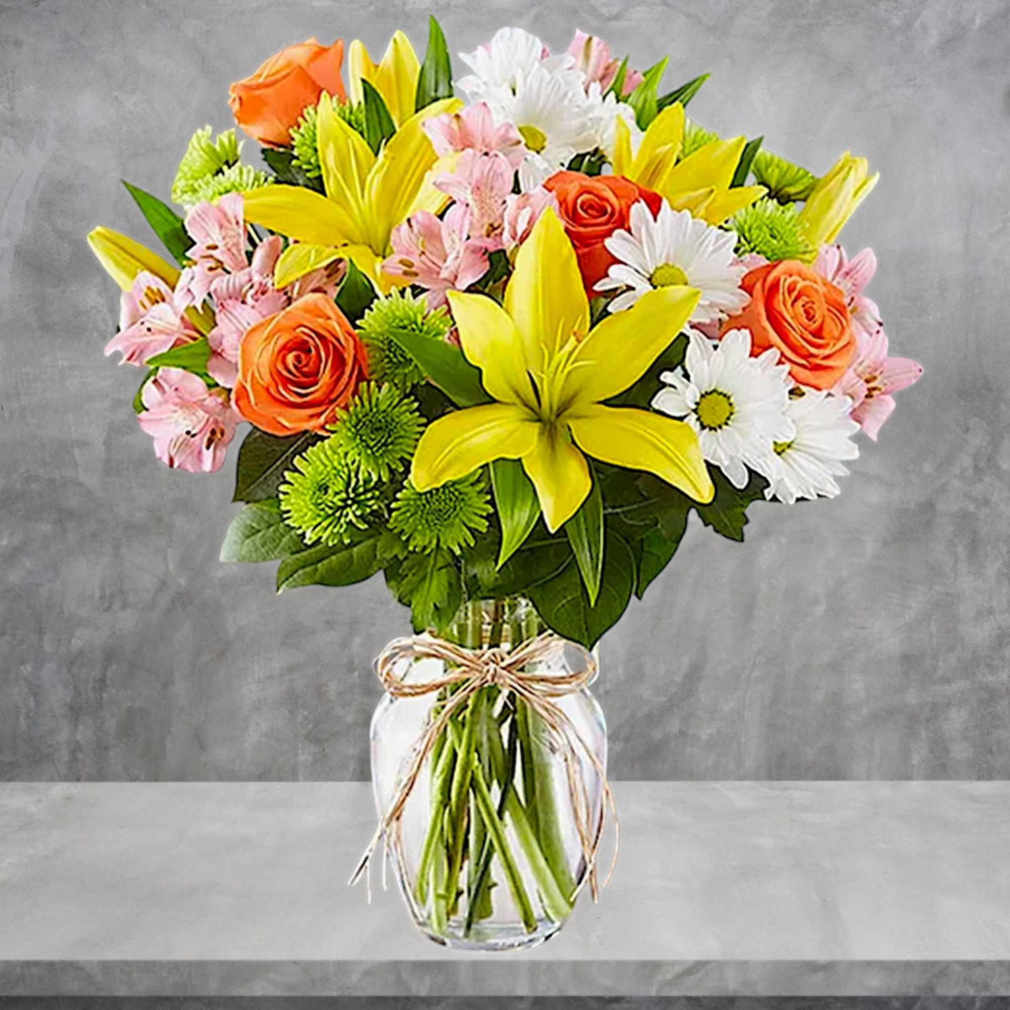 Bouquet of yellow lilies, orange roses, and white daisies in a glass vase, photo 3 of 5