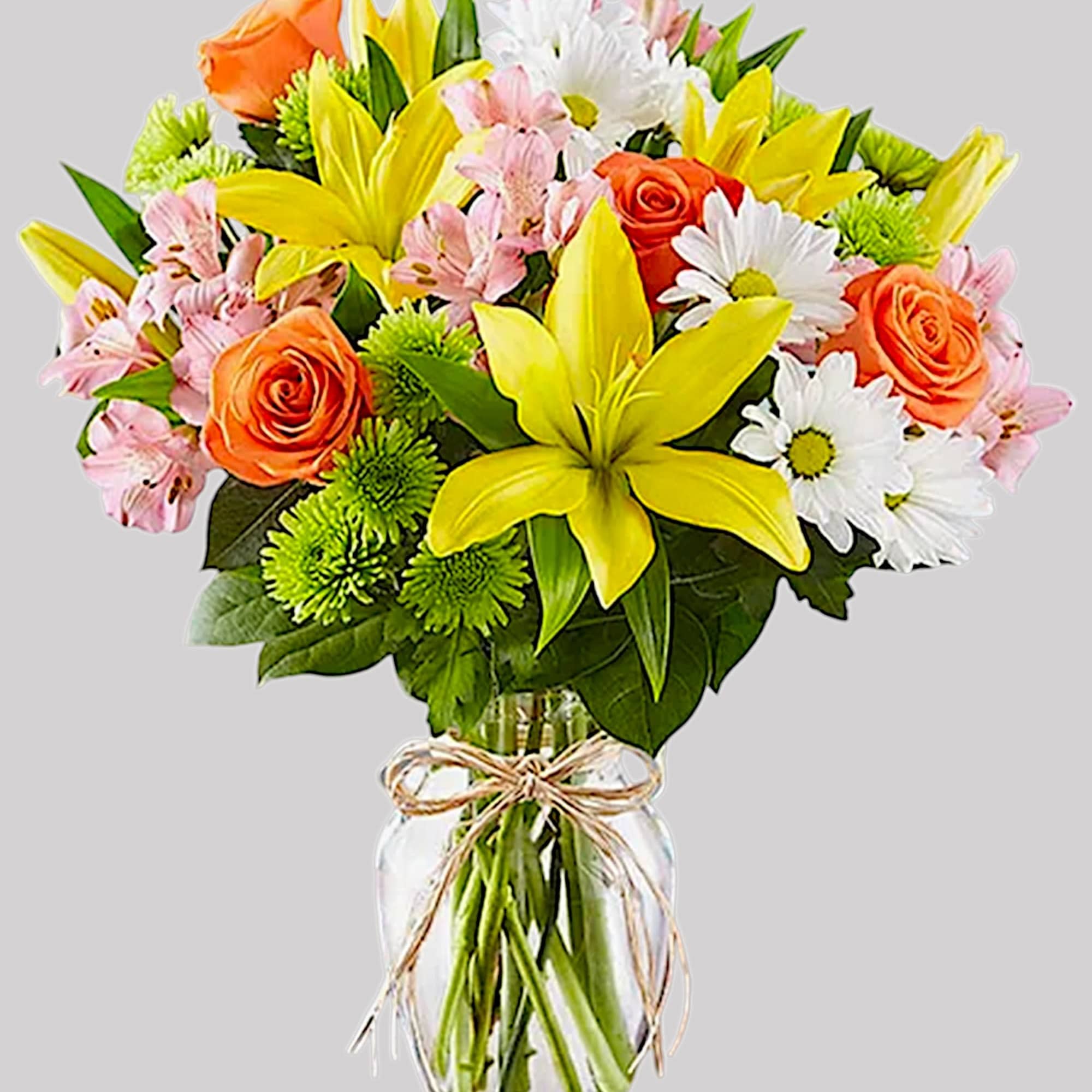Bouquet of yellow lilies, orange roses, pink alstroemeria, and white daisies in a glass vase