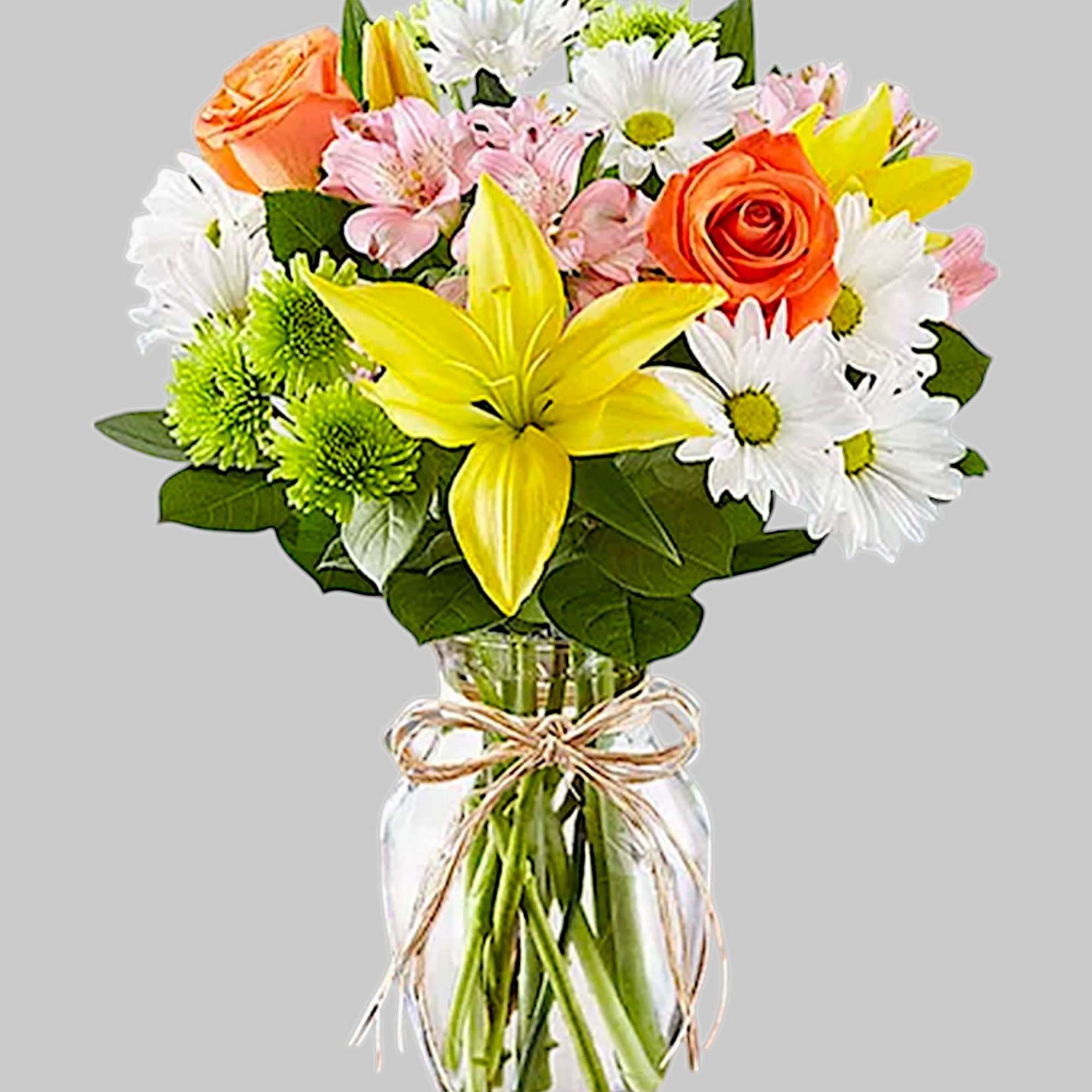 Mixed bouquet of lilies, roses, daisies, and alstroemeria in a glass vase