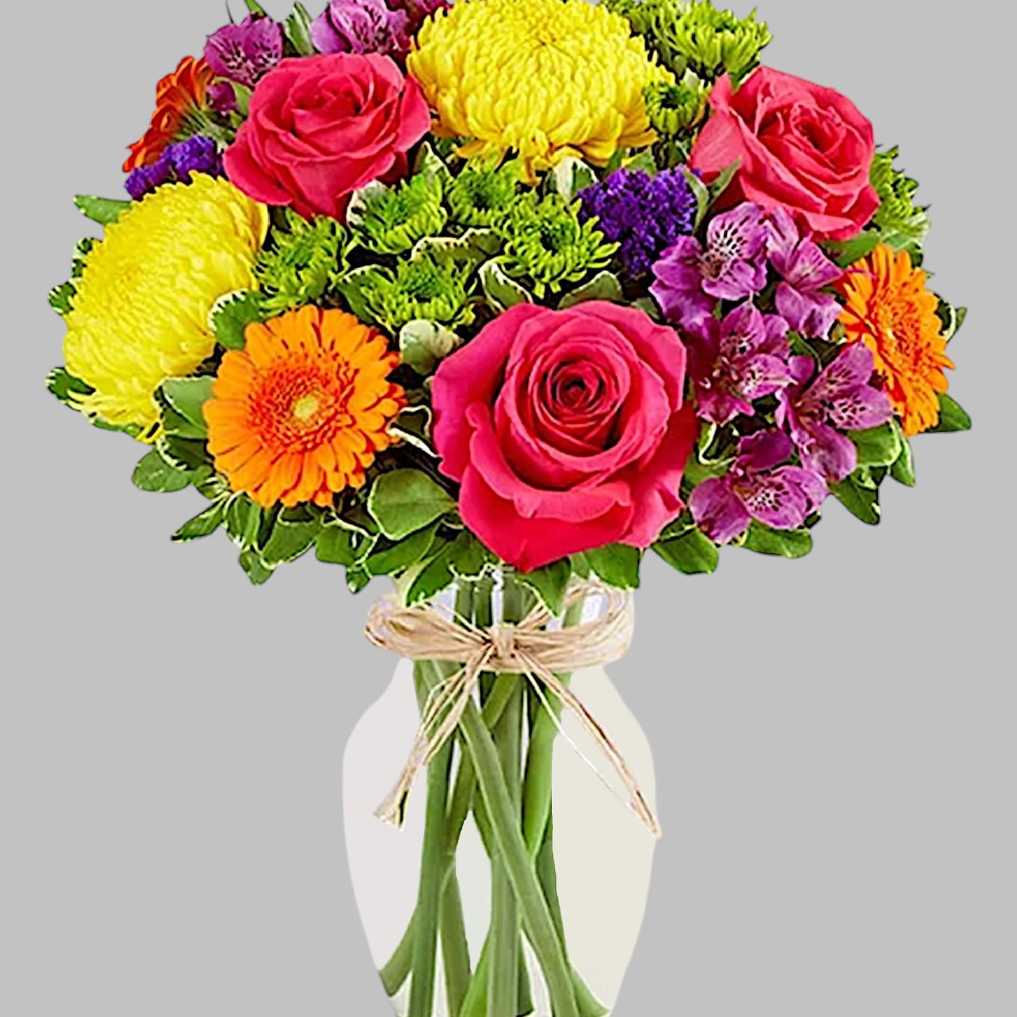 Colorful bouquet of roses, chrysanthemums, and gerbera daisies in a glass vase