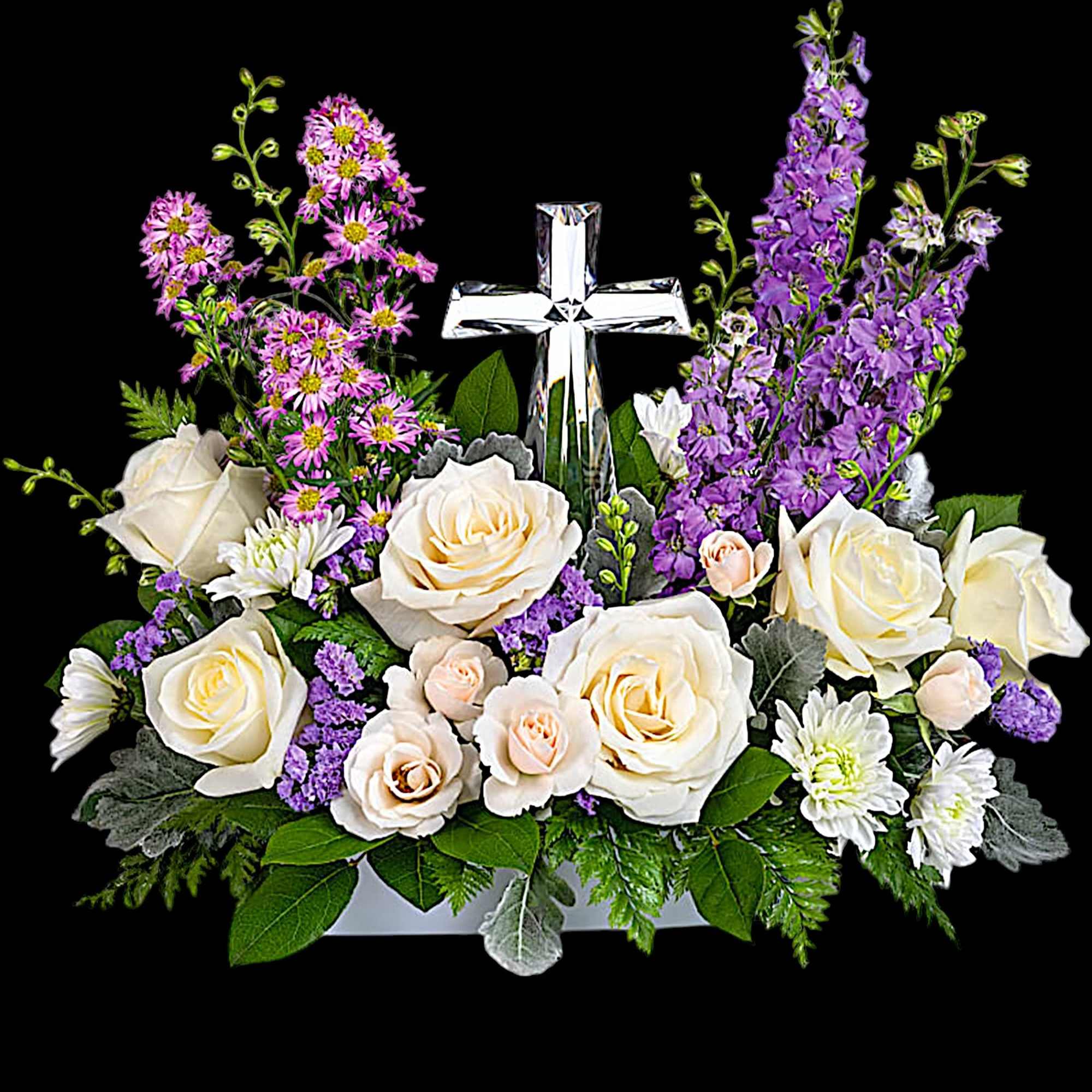 White roses and purple flowers arranged around a clear cross