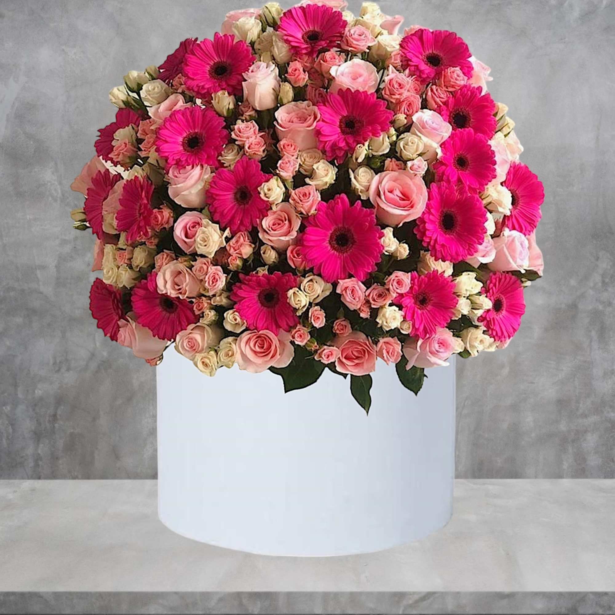 Red roses are beautifully arranged in a white cylinder box. Have them, photo 2 of 4